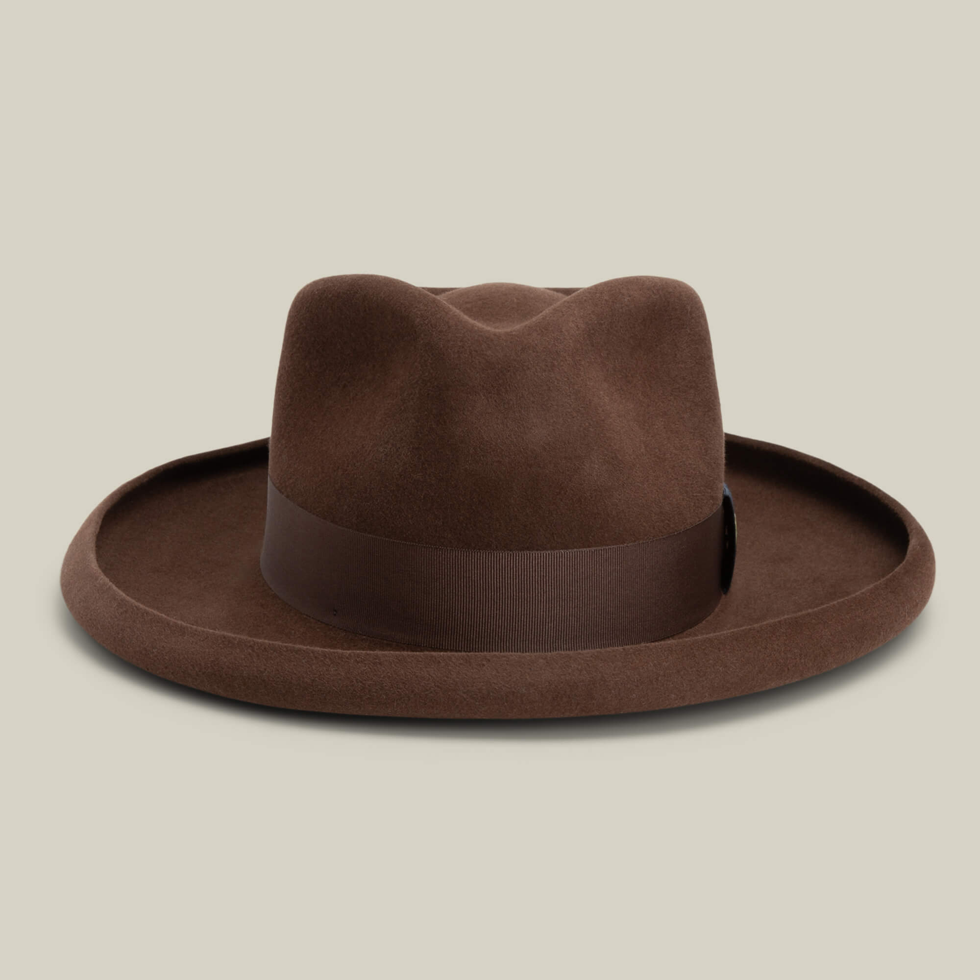 The Colonel Pierce by Goorin Bros. is a brown felt fedora featuring a teardrop crown, wide brim, and matching brown ribbon band, shown against a neutral background.