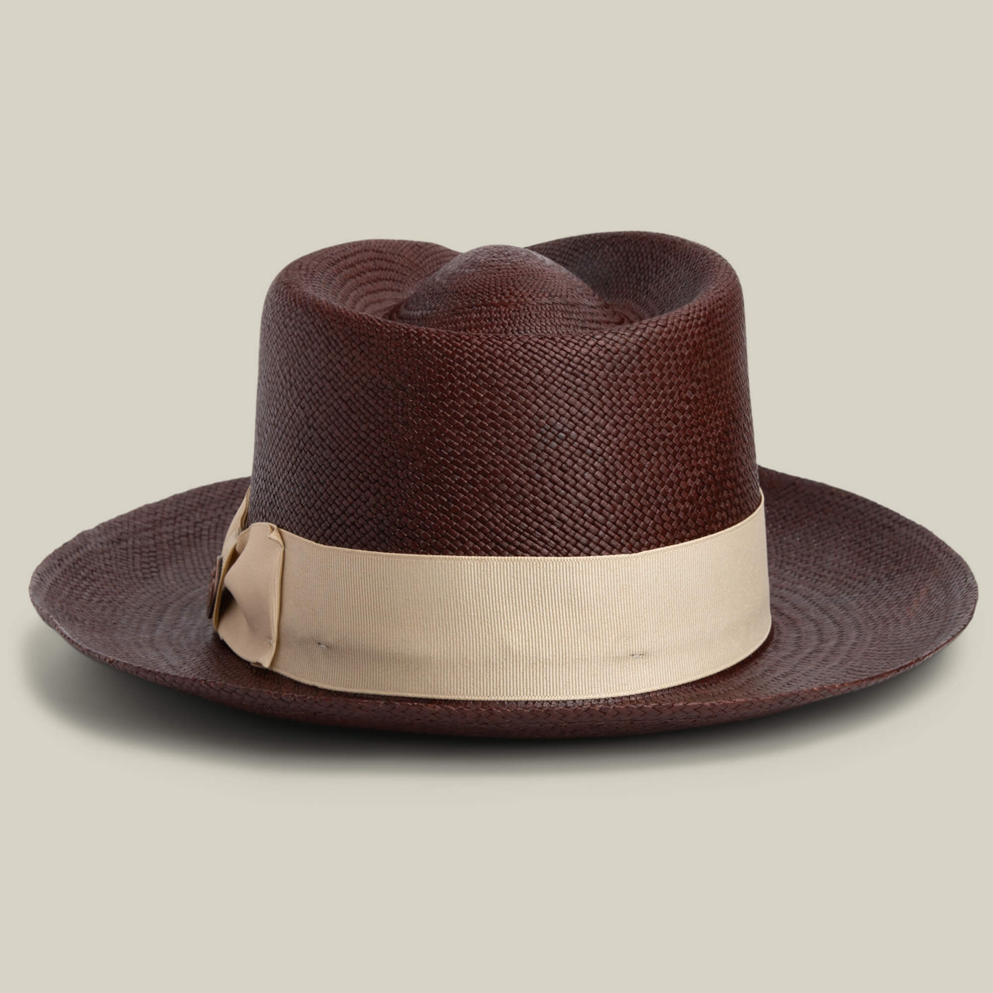 The Goorin Bros. John Sr. is a brown textured toquilla teardrop fedora with a wide brim, beige ribbon band, and 50 UPF sun protection, shown against a plain light background.