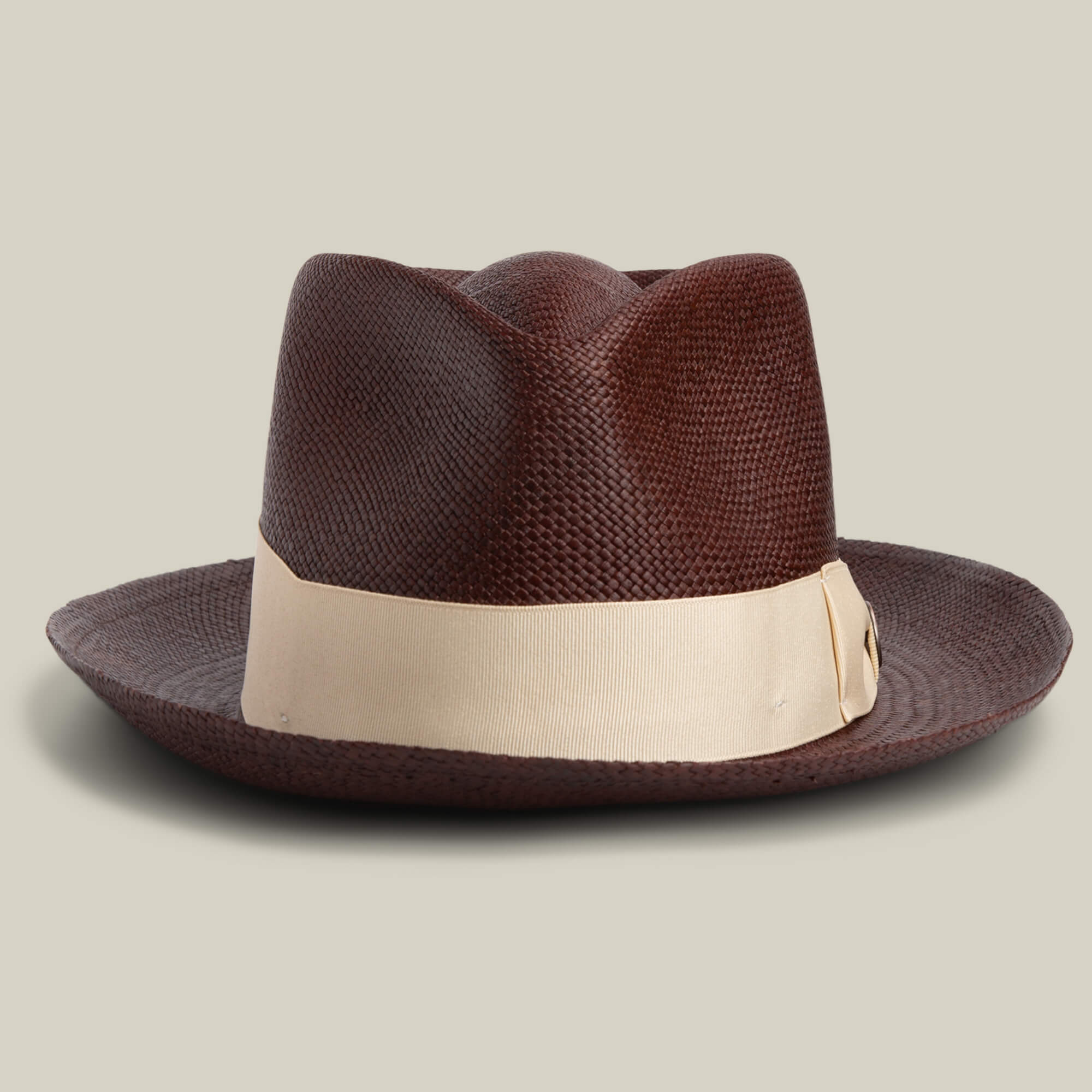 The Goorin Bros. John Sr. is a dark brown toquilla teardrop fedora with a textured finish, wide light beige ribbon, and 50 UPF sun protection, shown against a plain background.