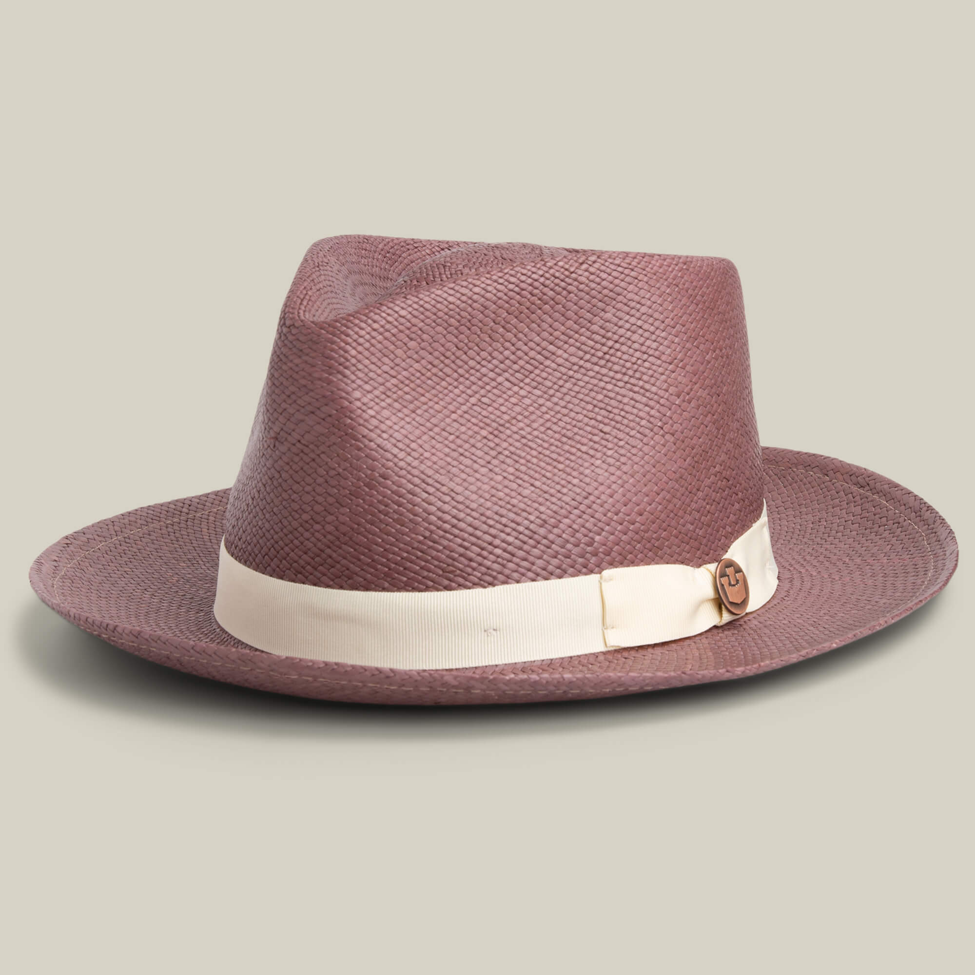 The John Sr. by Goorin Bros. is a brown toquilla teardrop fedora with a wide brim, 50 UPF sun protection, a cream ribbon band, and a small circular pin.