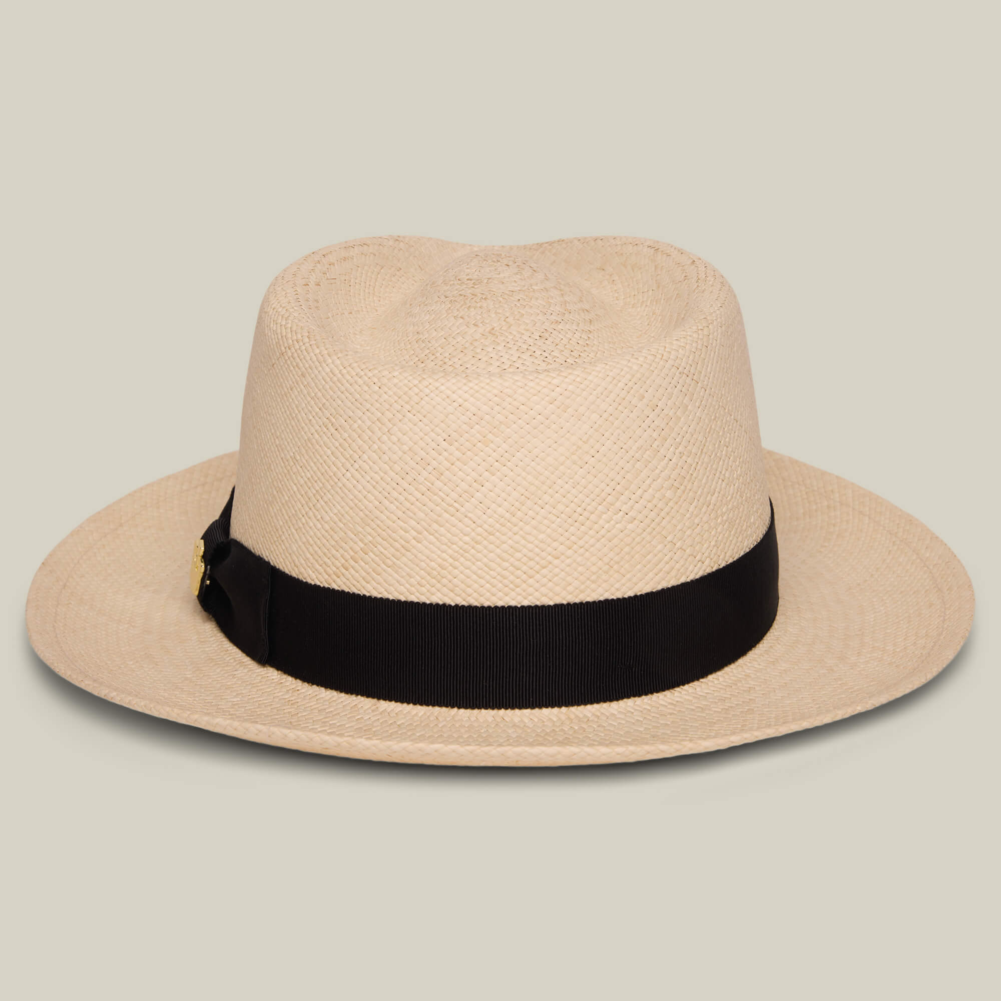 The Goorin Bros. John Sr. is a beige toquilla fedora hat with a wide brim and black ribbon band, offering 50 UPF sun protection, displayed on a neutral background.