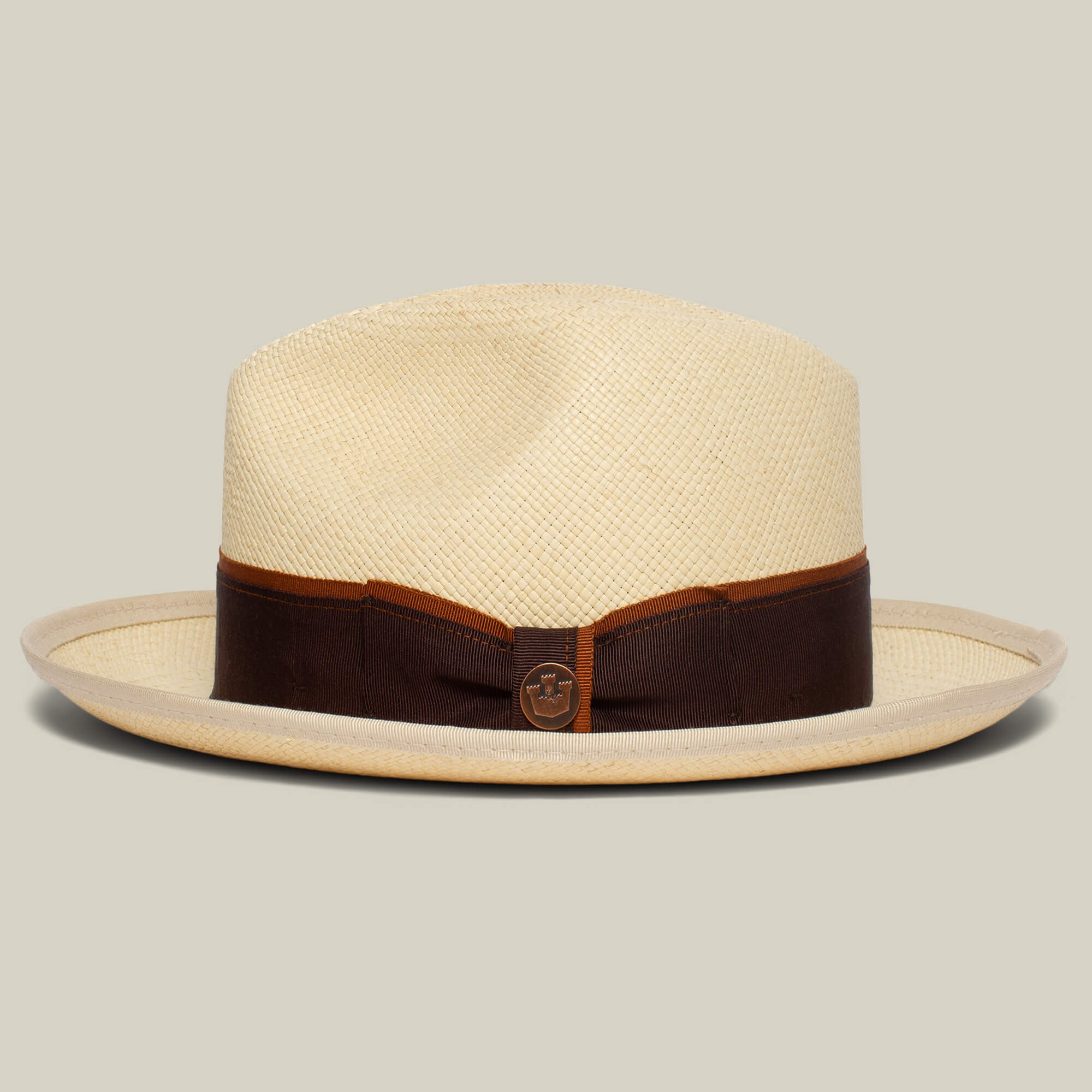 The Goorin Bros. Hartman is a light straw fedora with a wide brim, contrast edge, dark brown grosgrain band, and a small circular emblem on the front.