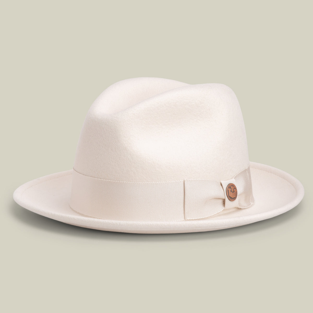 Dean the Butcher by Goorin Bros. is an American-made fedora in DUST, featuring a wide brim and a matching ribbon band, displayed on a neutral background.