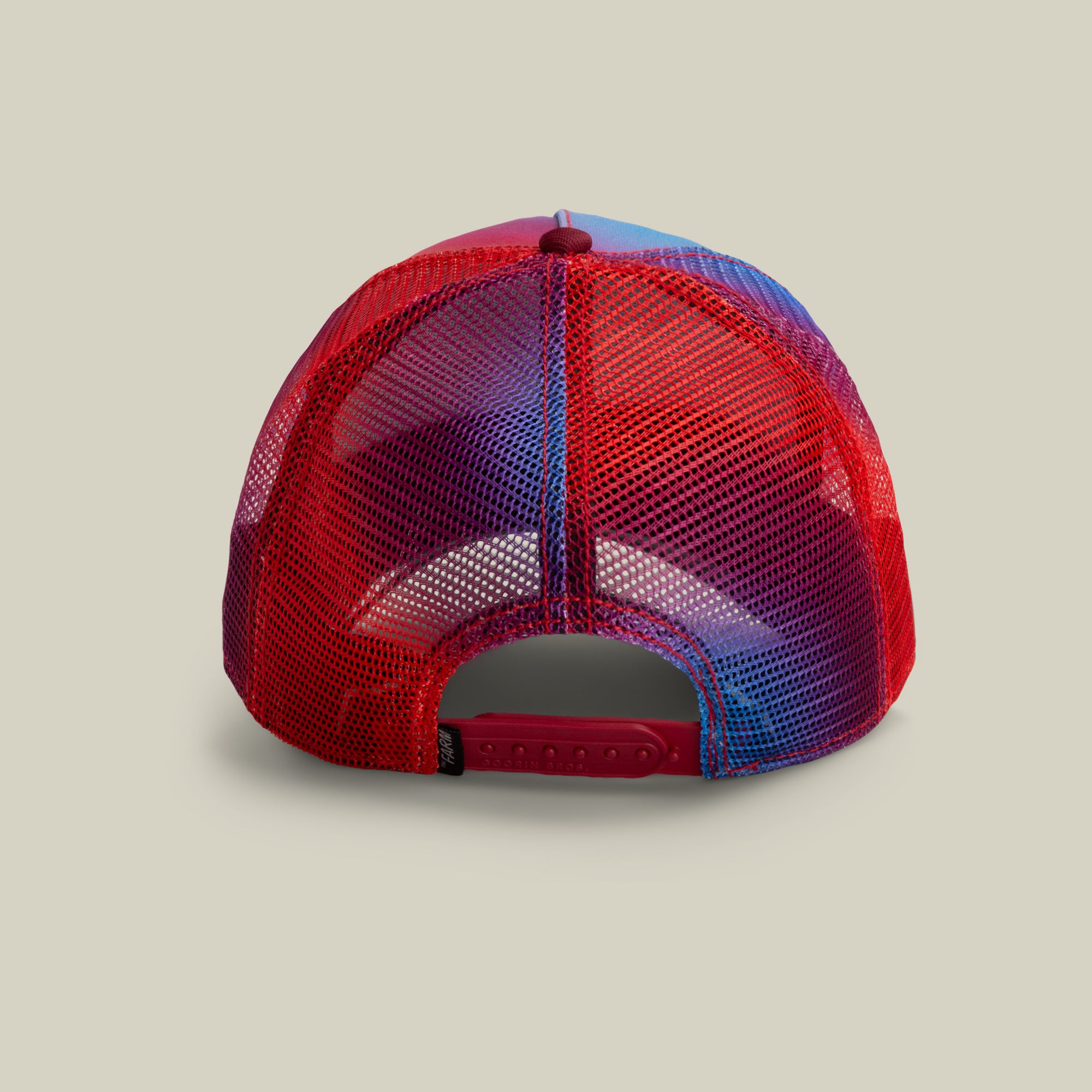A back view of the Bird is the Word red and blue mesh trucker hat by The Farm, featuring an adjustable snapback closure. All sales are final.