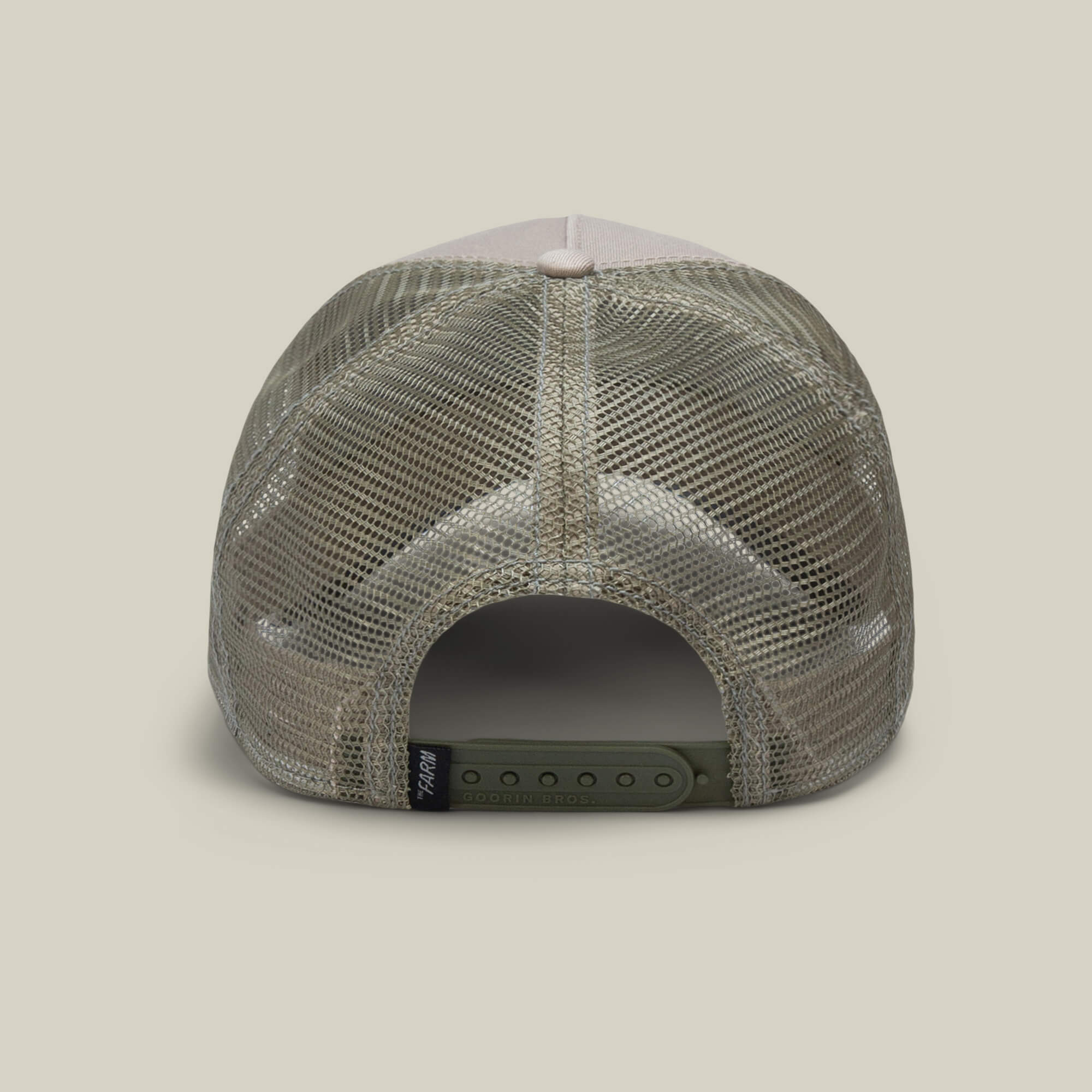 The Bandit Coyote by The Farm is a khaki mesh trucker hat shown from the back with an adjustable snapback and a small black tag on the left—ideal for anyone with outlaw energy and a wild spirit.