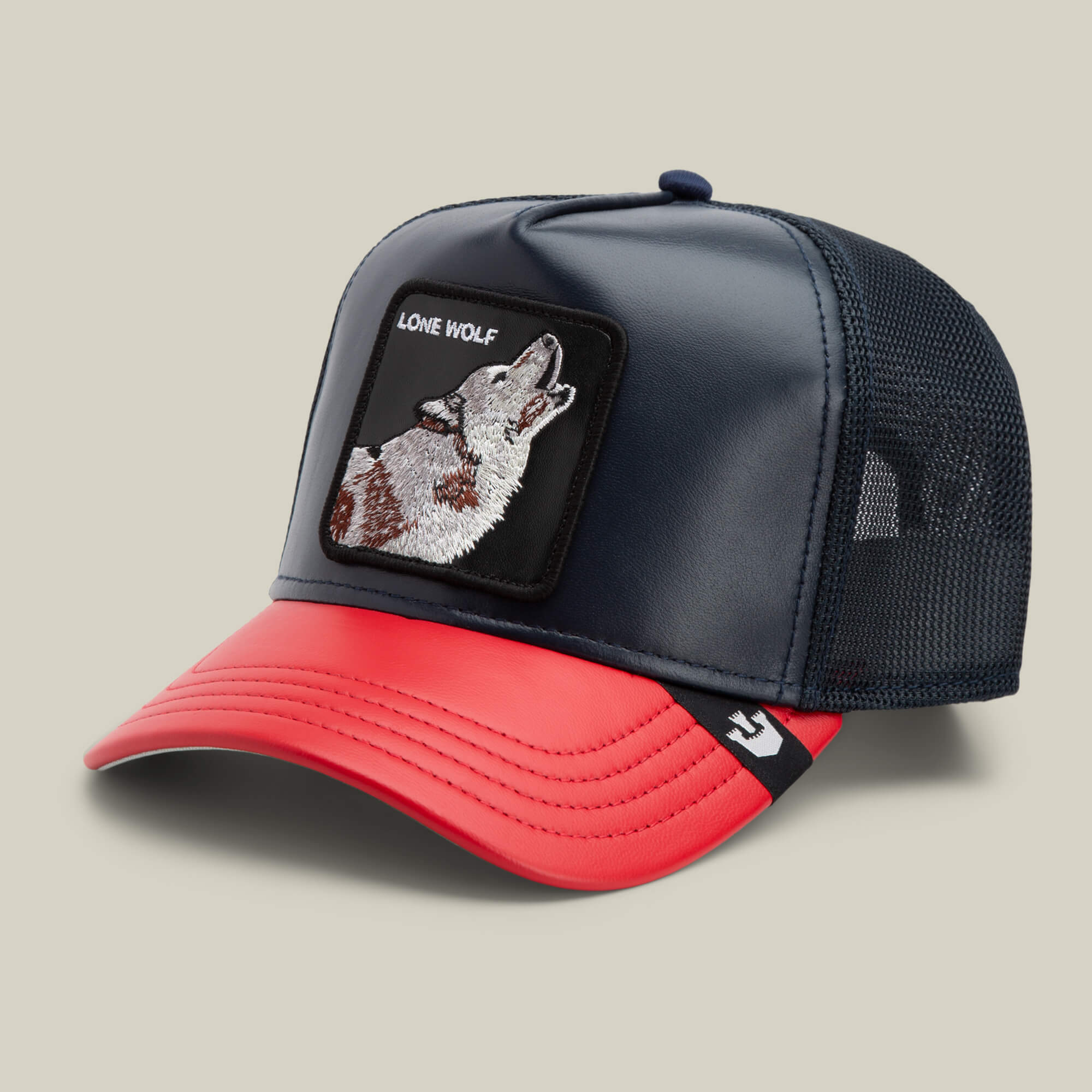 The Farm’s Shleather Wolf trucker hat features a navy mesh back, red brim, and an embroidered howling wolf patch with "LONE WOLF" text—perfect for bold, on-trend style.