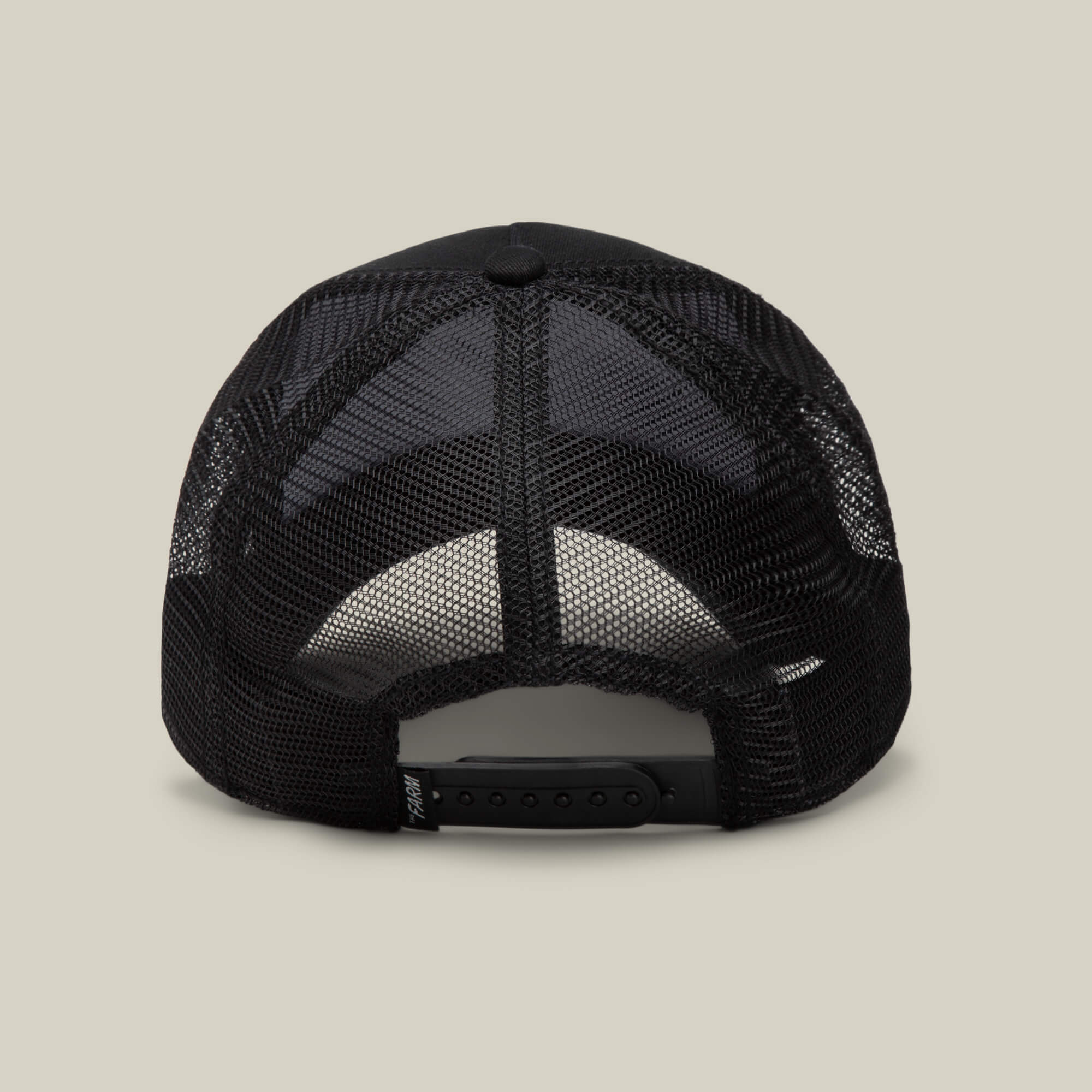 The image displays the back of a black mesh Goorin Bros. EK65 Penguin trucker cap with an adjustable snapback, set against a plain light background. This cap is part of a limited drop collection.
