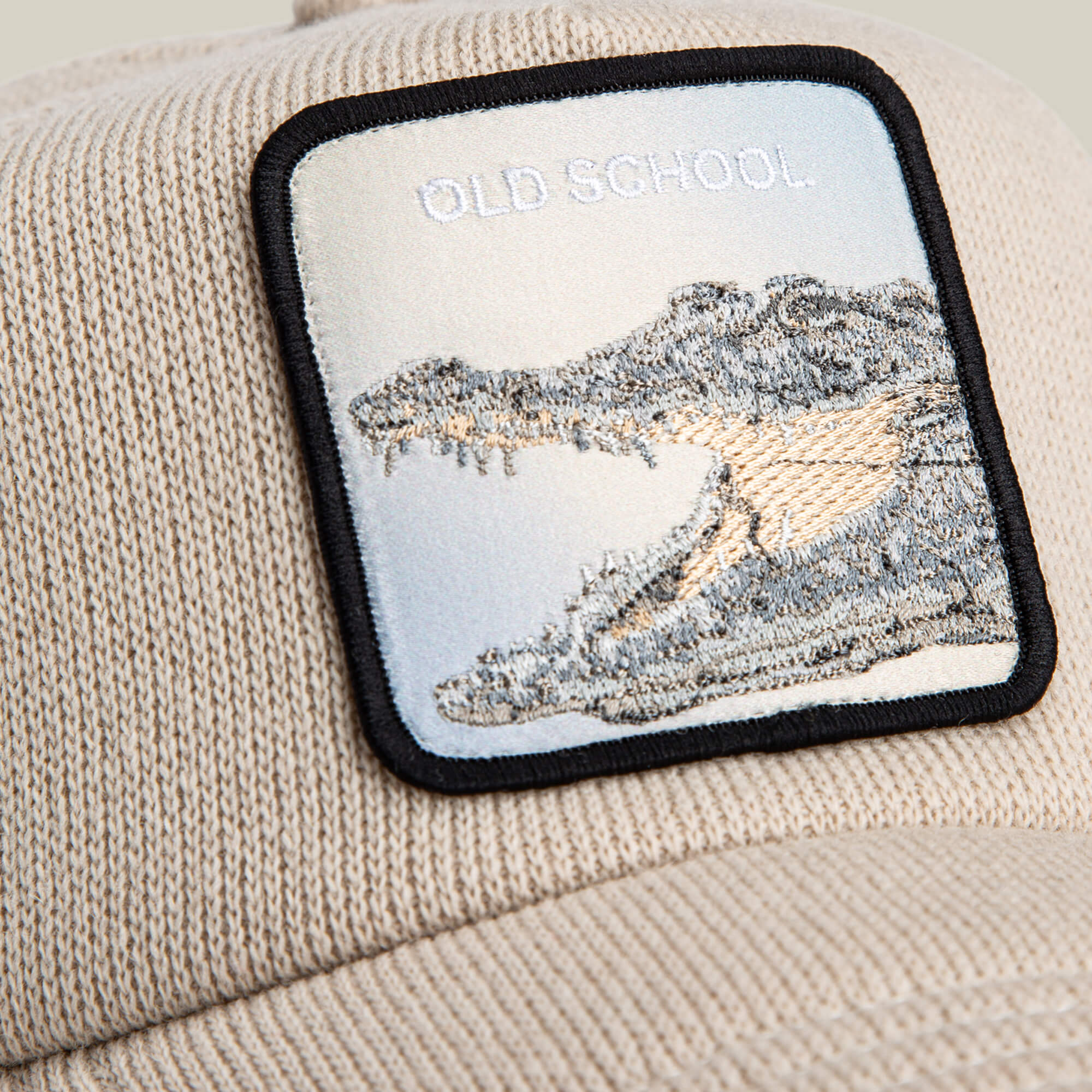 The Goorin Bros. AllmiMator is a beige knit beanie trucker cap with a rectangular patch showing an open-mouthed crocodile and "OLD SCHOOL" embroidered above it.