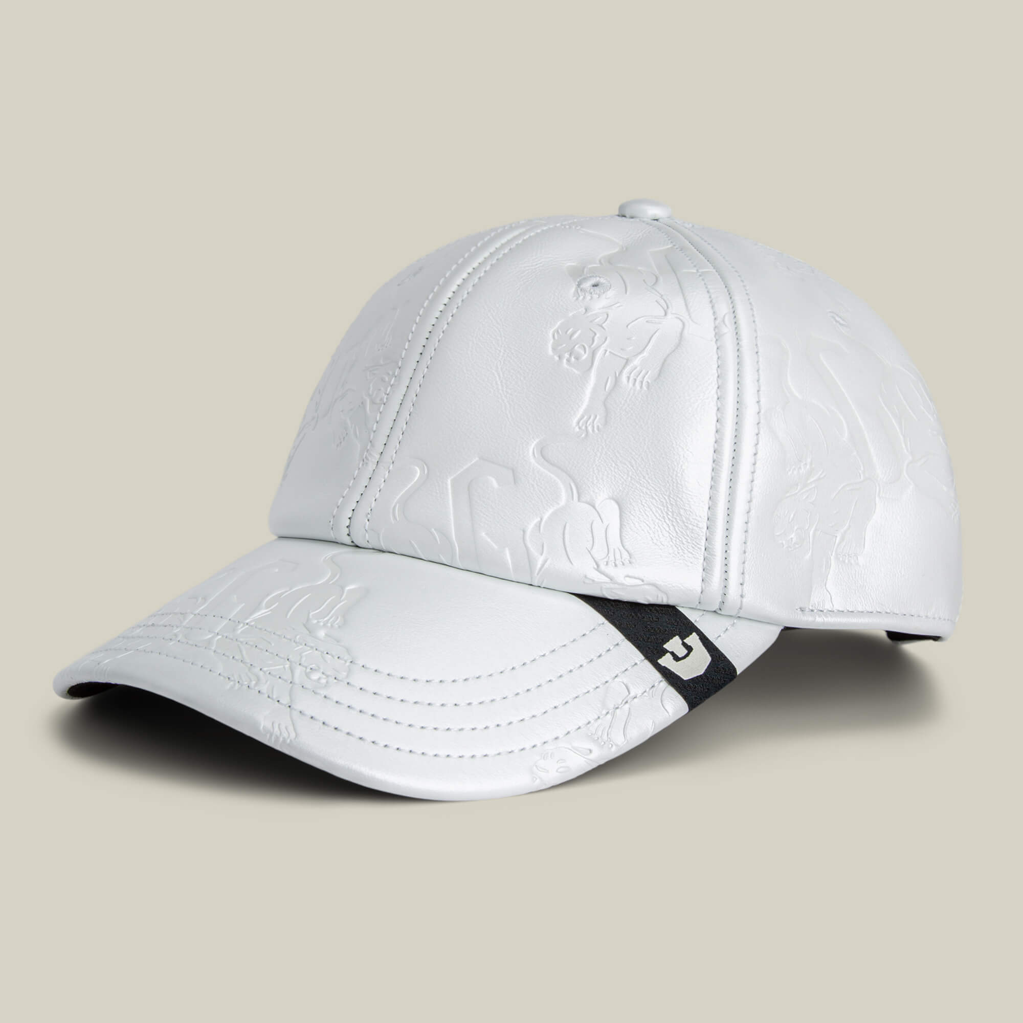 The "Put a Panther On It" hat by Goorin Bros. is a white leather cap featuring embossed animal designs and a black logo tag on the brim, shown against a neutral background.