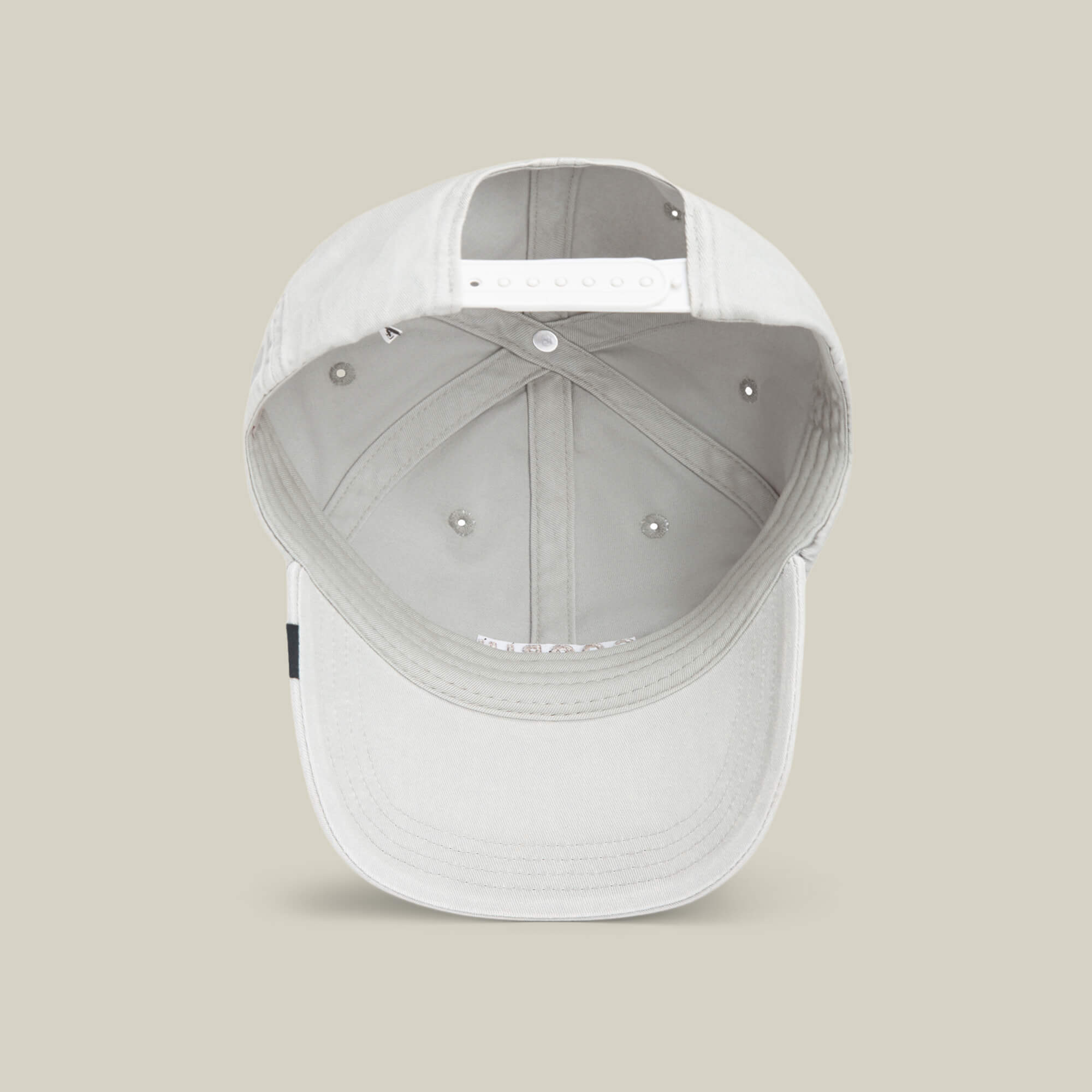 A light grey Goorin Bros. Papa Cap Italiano baseball cap is shown from the inside, featuring an adjustable snap closure and interior stitching details, set against a neutral background.