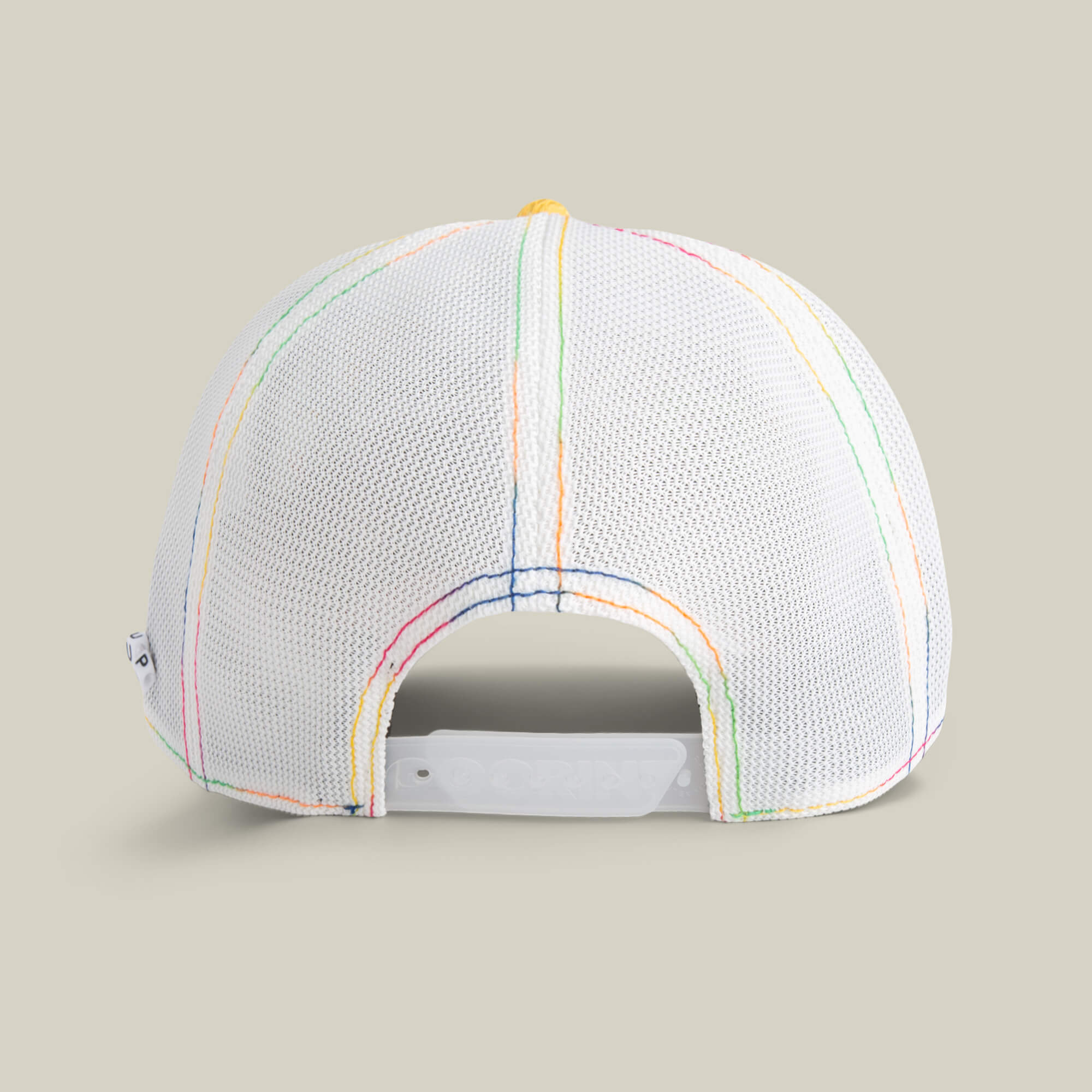 A white mesh baseball cap by Goorin Bros., called Drum and Bass, viewed from the back with multicolored stitching and an adjustable snap closure—a stylish festival hat for bass music fans.