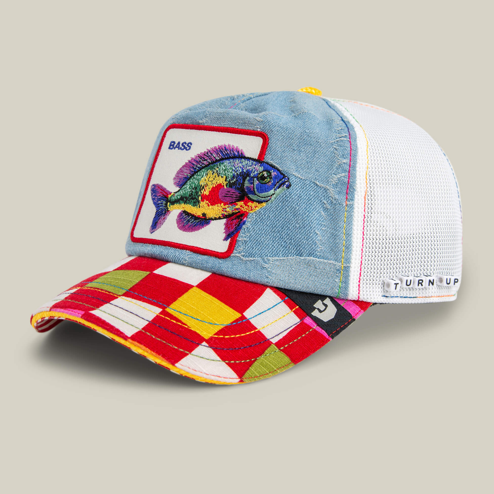 The Drum and Bass cap by Goorin Bros. features a red/yellow plaid brim, blue denim front with an embroidered BASS fish, and a white mesh back—ideal as a festival hat for drum and bass music fans.