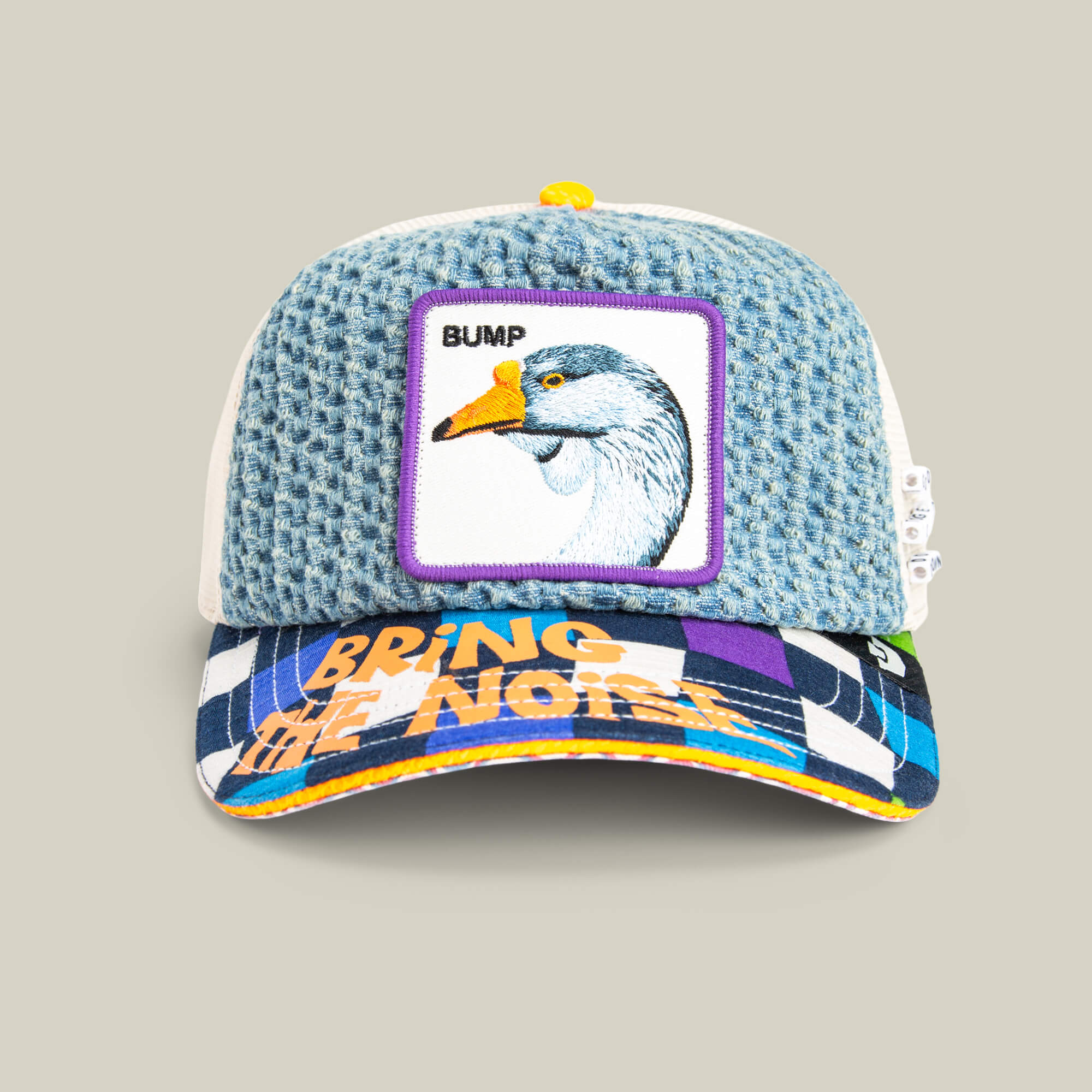 The Goorin Bros. Acid House cap features a blue textured crown, a goose BUMP patch, and a colorful BRING THE NOISE brim—perfect for Acid House fans heading to the next laser dome party.