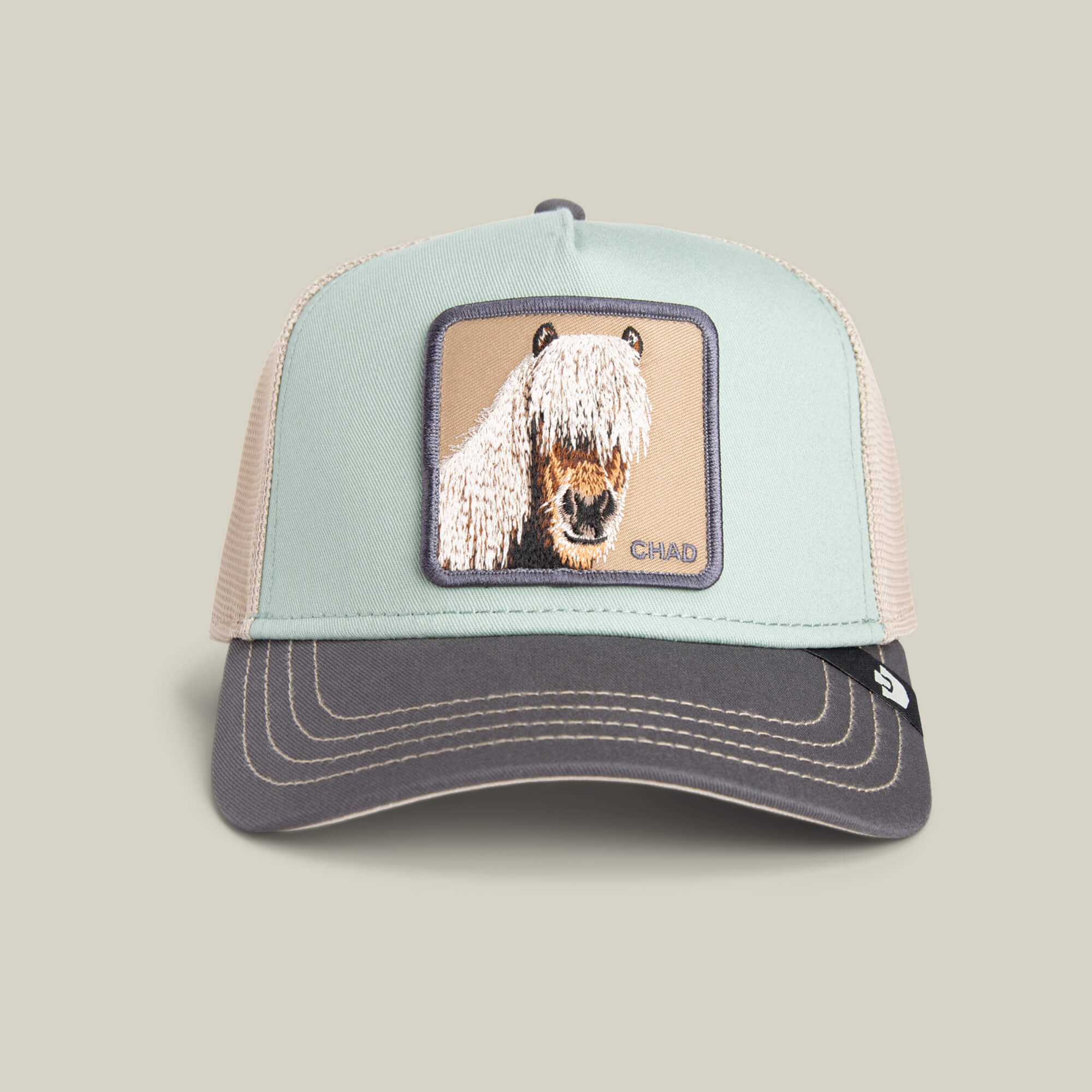 The Goorin Bros. Tricolor Horse is a two-tone trucker hat featuring an embroidered horse with long hair over its eyes—ideal for fans of the fringe horse hat trend.