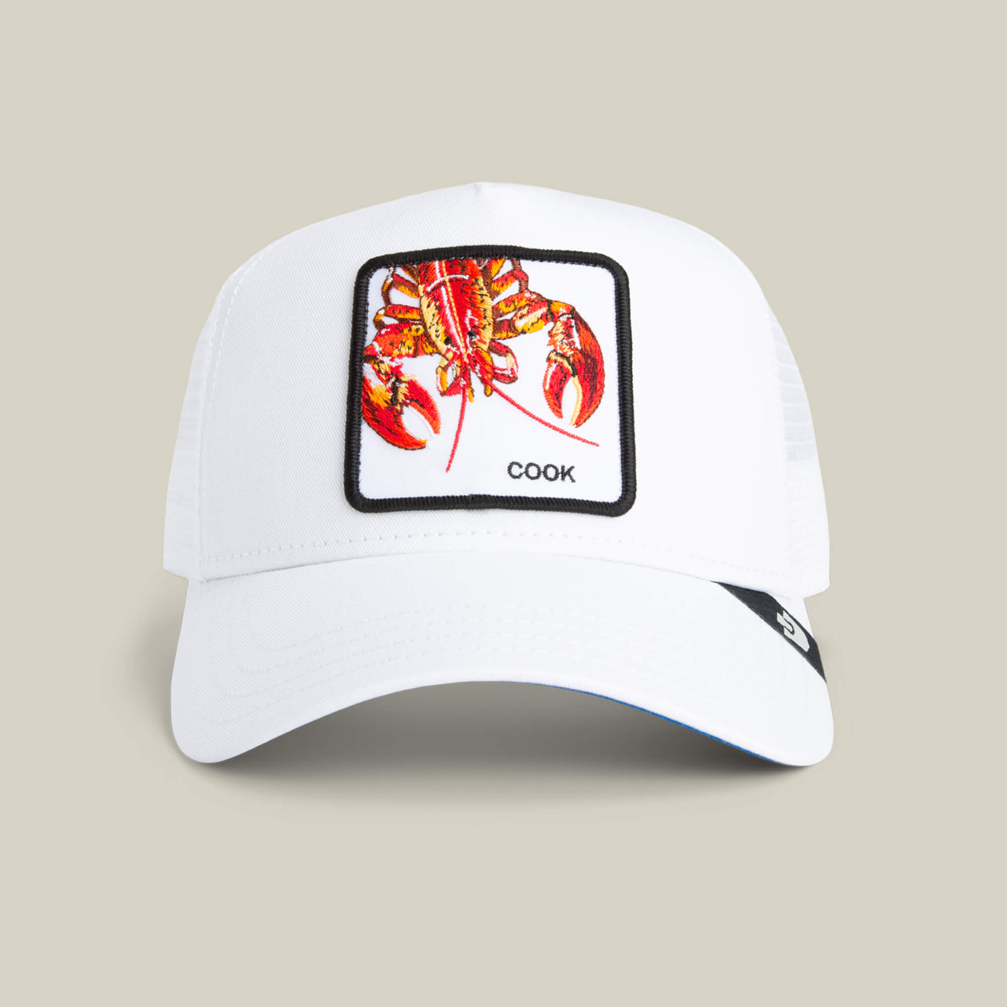 The Goorin Bros. Lemme Cook is a white lobster hat with a colorful embroidered lobster patch, "COOK" beneath, and a breathable mesh back for comfort.