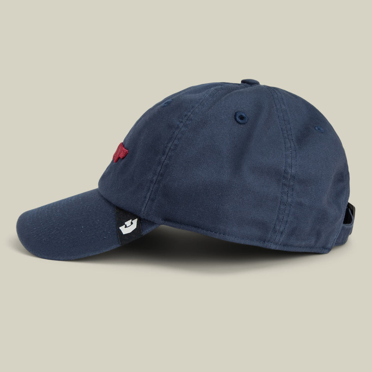 The Goorin Bros. Papa Core is a navy blue corduroy dad hat with an embroidered red logo on the front and a small white patch detail on the side, displayed against a neutral beige background.