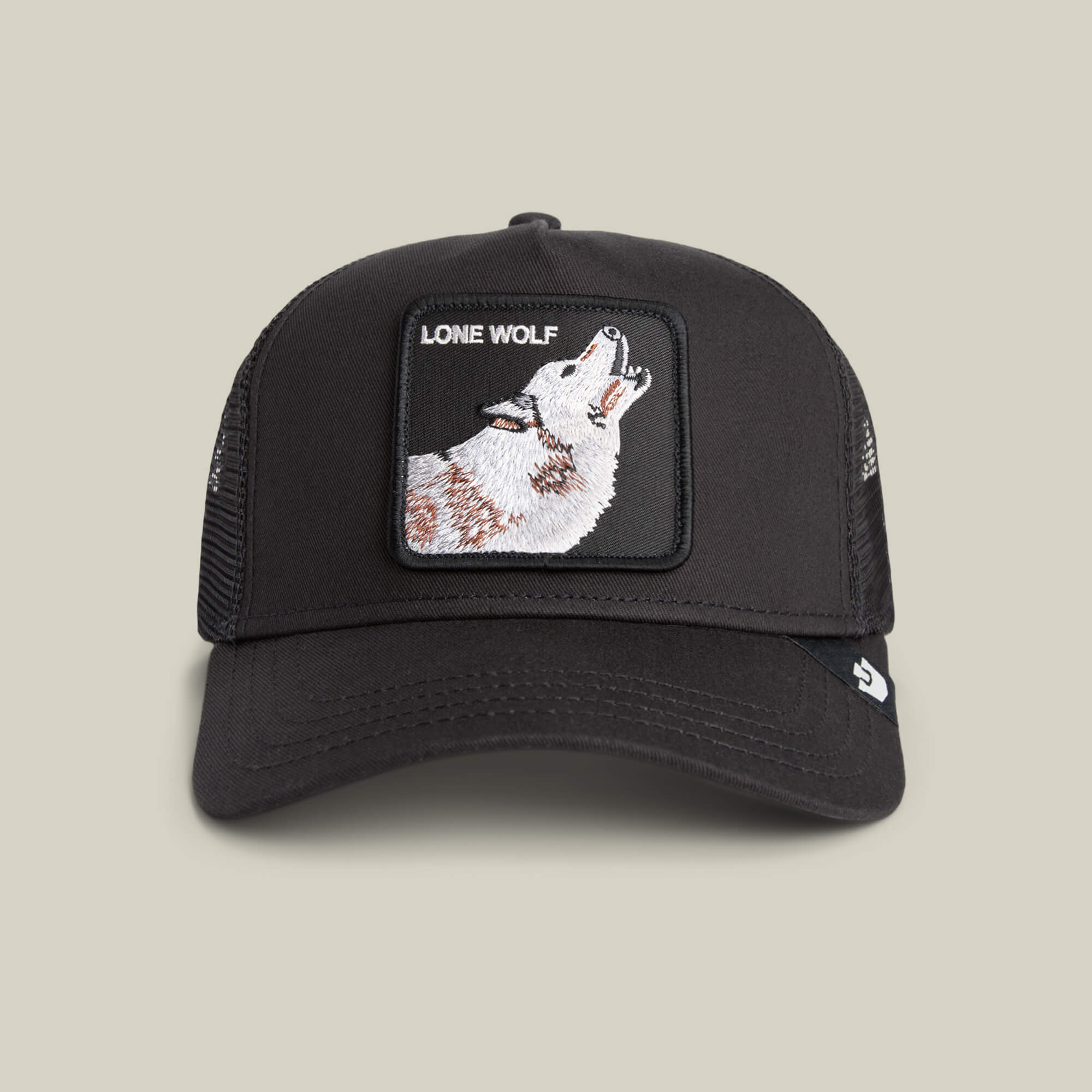 The Lone Wolf trucker hat by Goorin Bros. features mesh sides and a front patch with a howling wolf and "LONE WOLF" text—ideal for expressing your independent spirit.