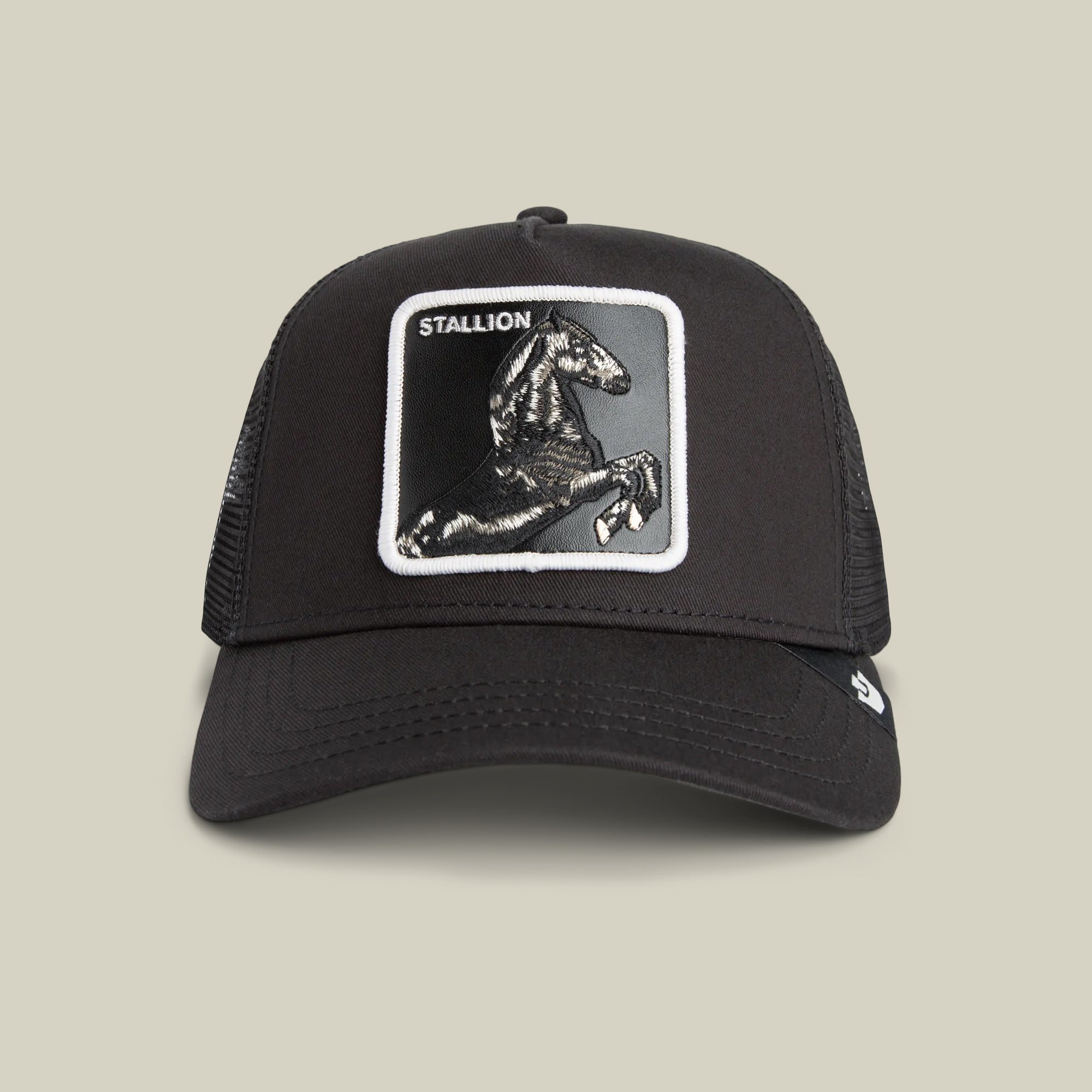 The Stallion Trucker by Goorin Bros. in VOID features a black and white mesh back with a front patch of a rearing black stallion and the word "STALLION.