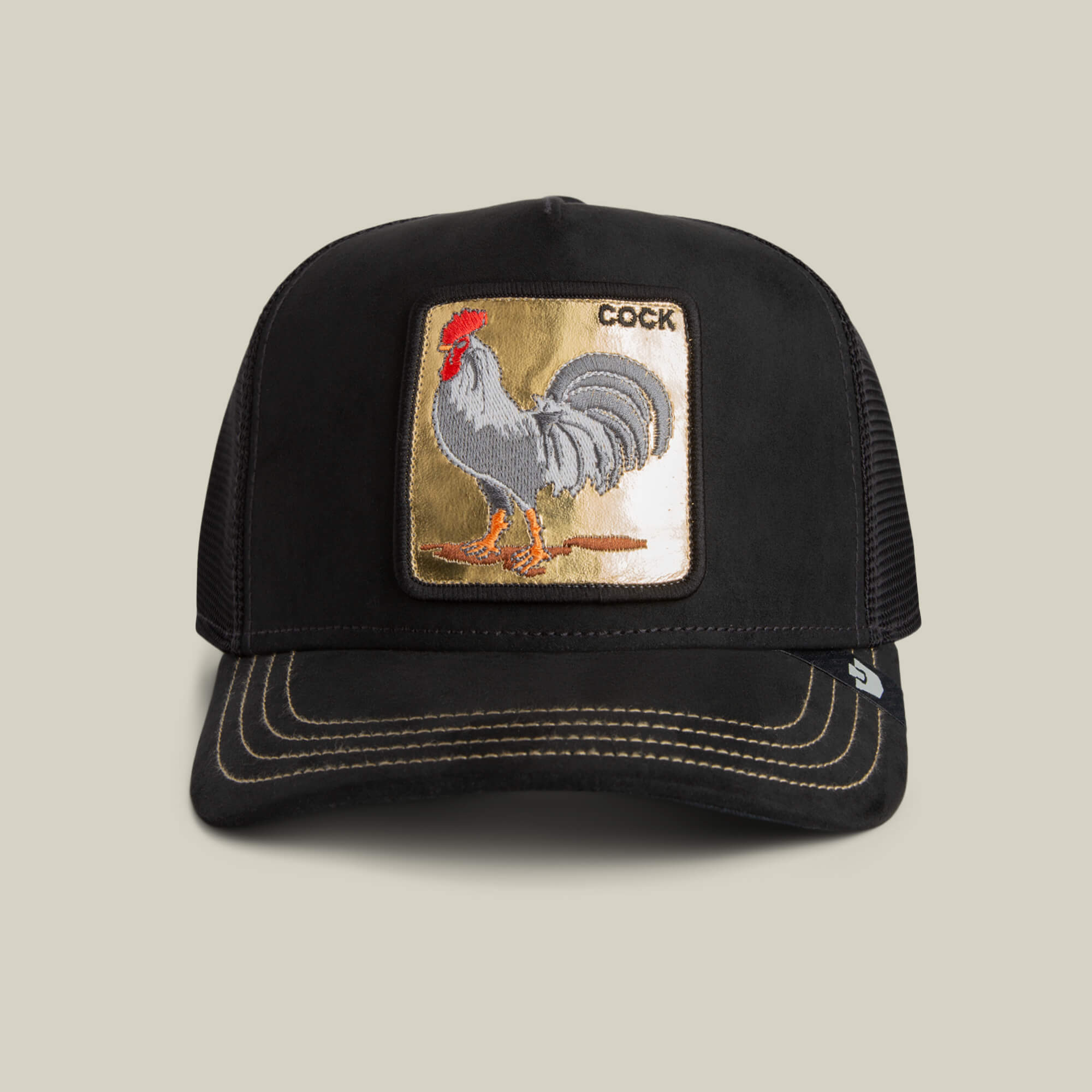 The Goorin Bros. Golden Cock cap is a black baseball hat featuring golden stitching and a front patch with an embroidered rooster and the word "COCK.