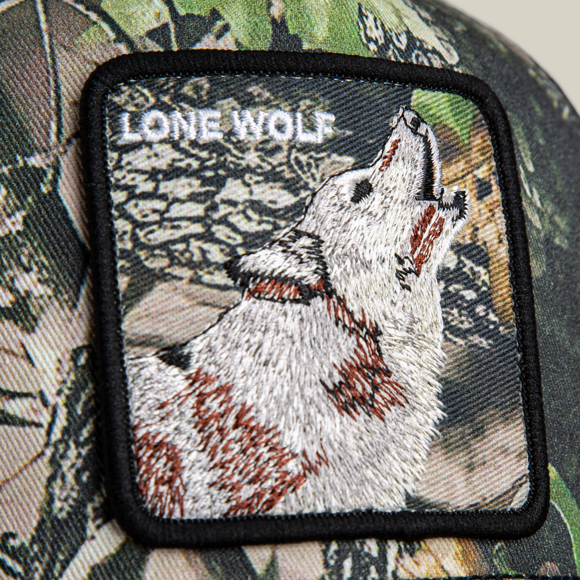 The Goorin Bros. Camouflage Lone Wolf patch features an embroidered howling wolf with "LONE WOLF" above, making a bold statement on camo material.