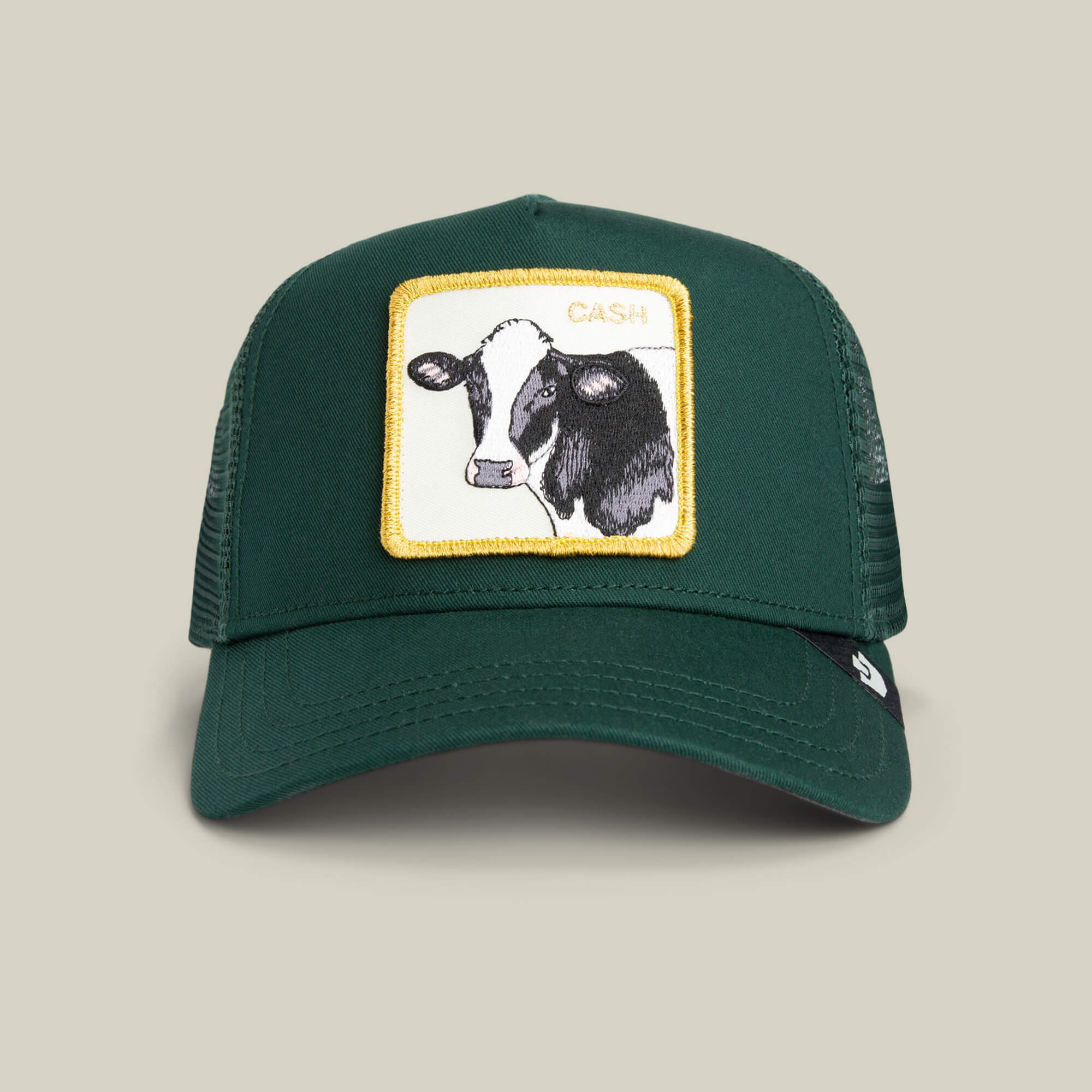 The Cash Cow Trucker by Goorin Bros. features a bold cow patch and "CASH" lettering on green mesh—a standout hat that makes a true statement.