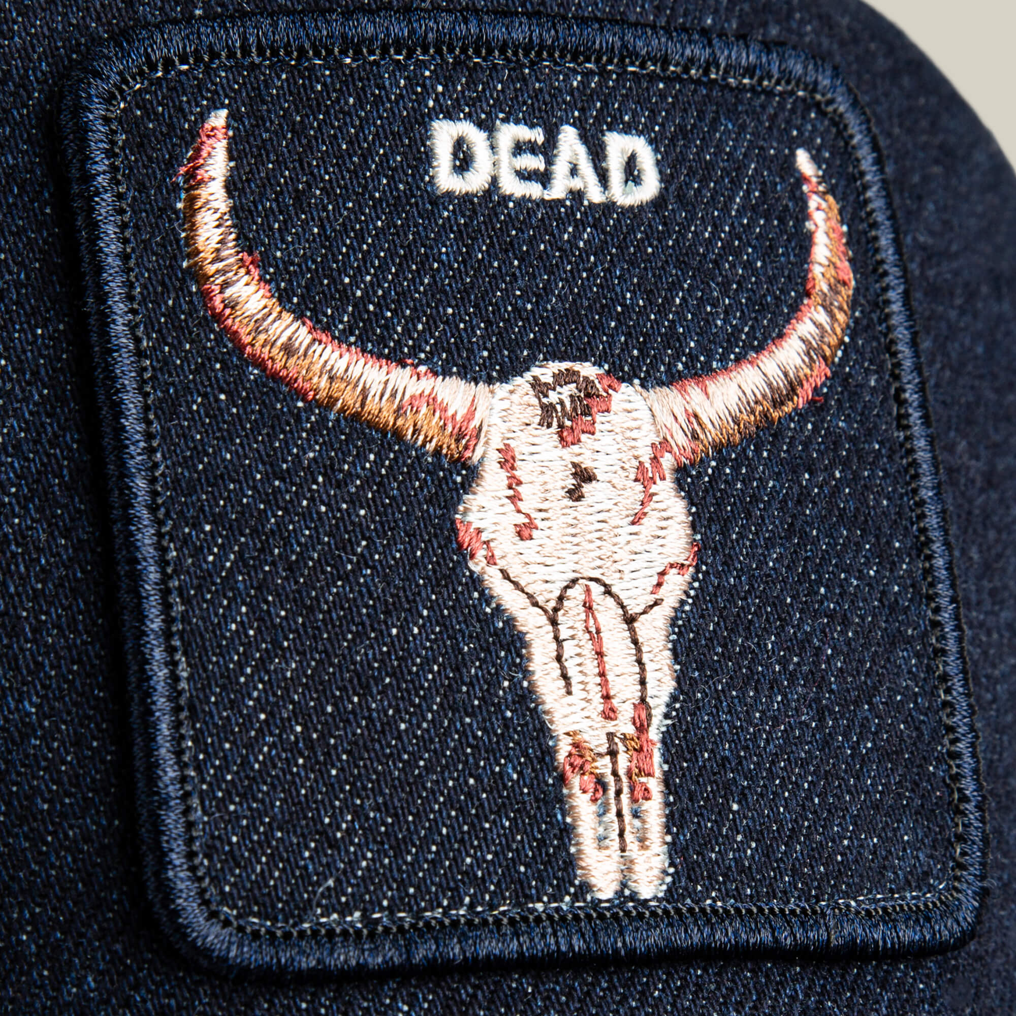 The Denim Dead patch by Goorin Bros. features bold bull skull embroidery and "DEAD" above it—ideal for customizing your favorite biker cap or skull denim hat.