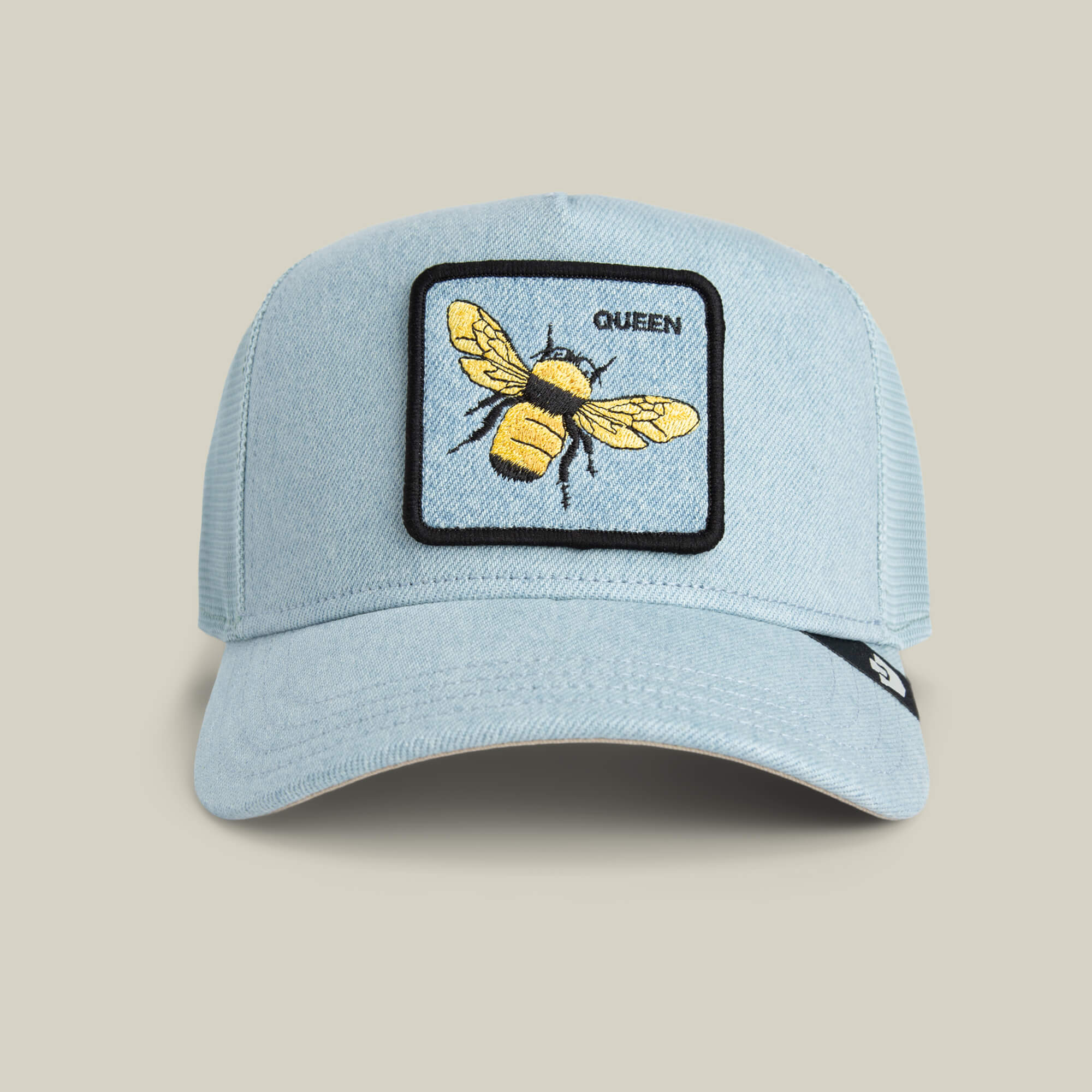 Show off your style with the Goorin Bros. Denim Queen trucker cap—a light blue hat featuring a denim crown and a square patch with an embroidered yellow bee and QUEEN, perfect for embroidered royalty flair.
