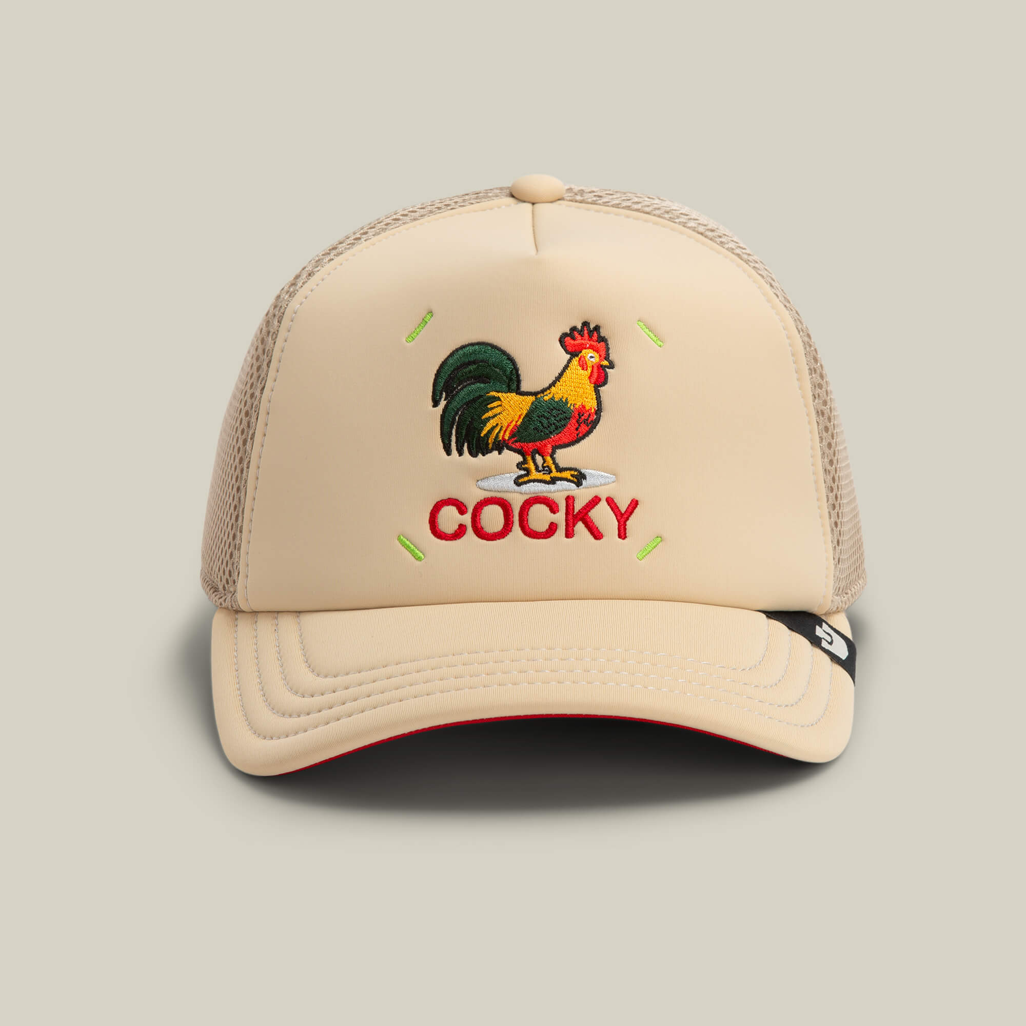 The Goorin Bros. Neo Farm - Cocky Rooster hat in TOAST features an embroidered rooster above “COCKY” in red—ideal for pairing with bold graphic tees or neutral outfits.