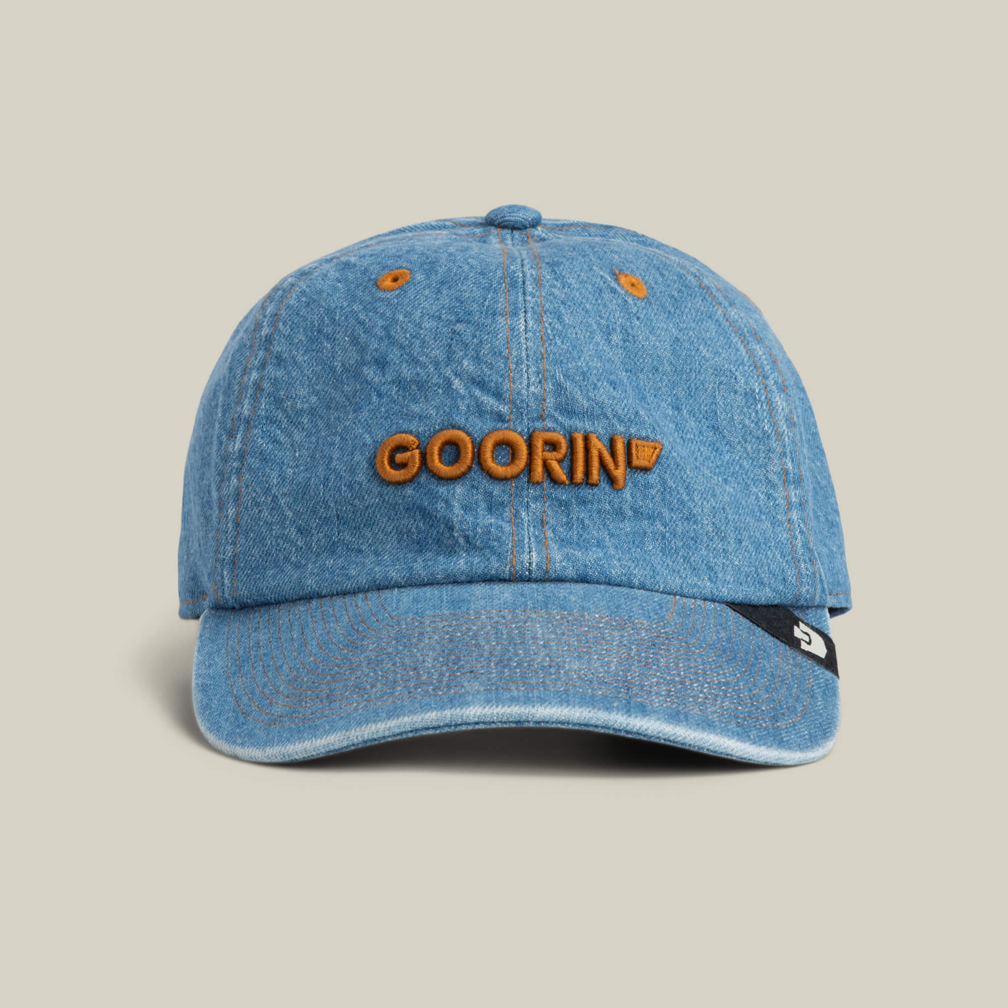 The Papa Core Denim hat by Goorin Bros. features a sky blue denim finish and an orange embroidered GOORIN wordmark on the front, shown against a plain background.
