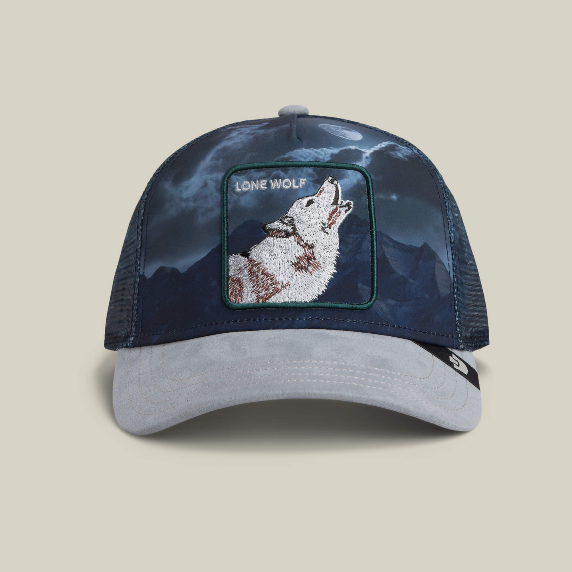 The Goorin Bros. Wolf In The Element trucker hat in GLOSS features a howling wolf patch with an embroidered mountain landscape and moon design.