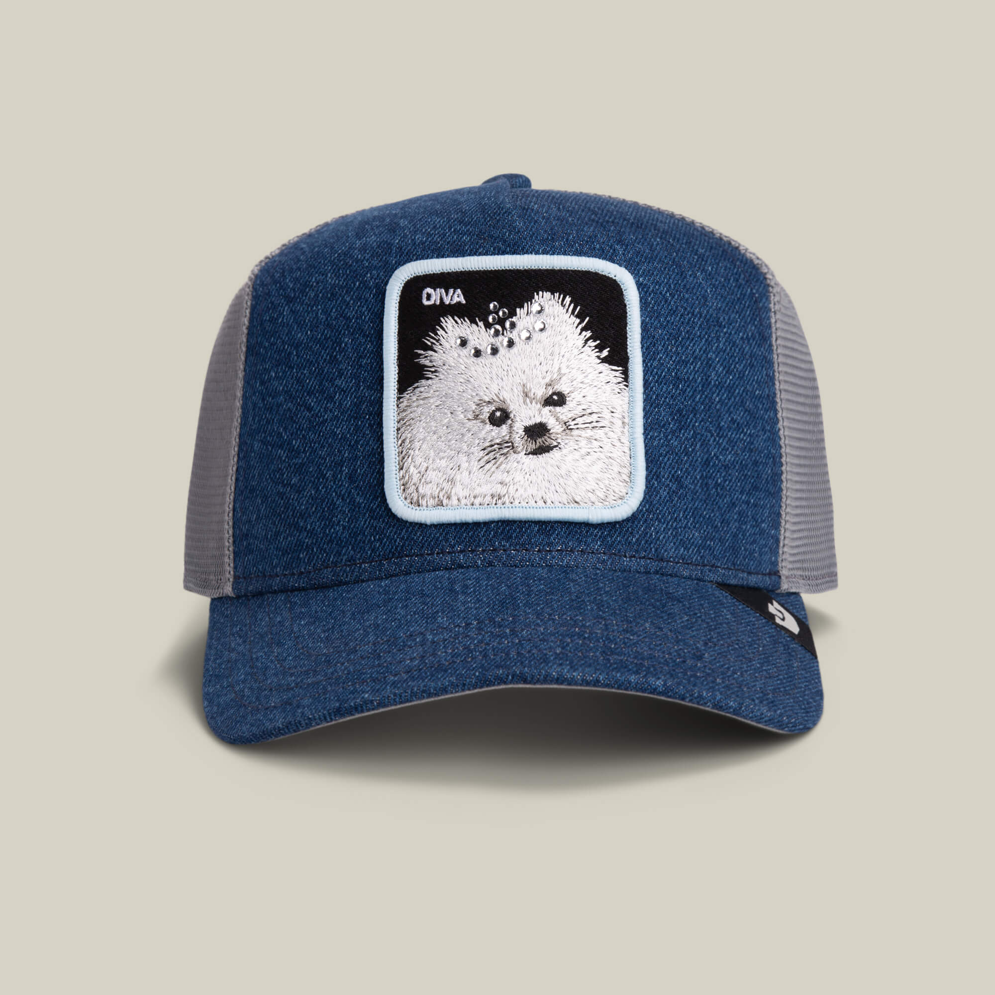 The Diva Dawg by Goorin Bros. is a light denim mesh trucker hat featuring a fluffy dog patch and DIVVA text—an ideal playful accessory for any diva dog.