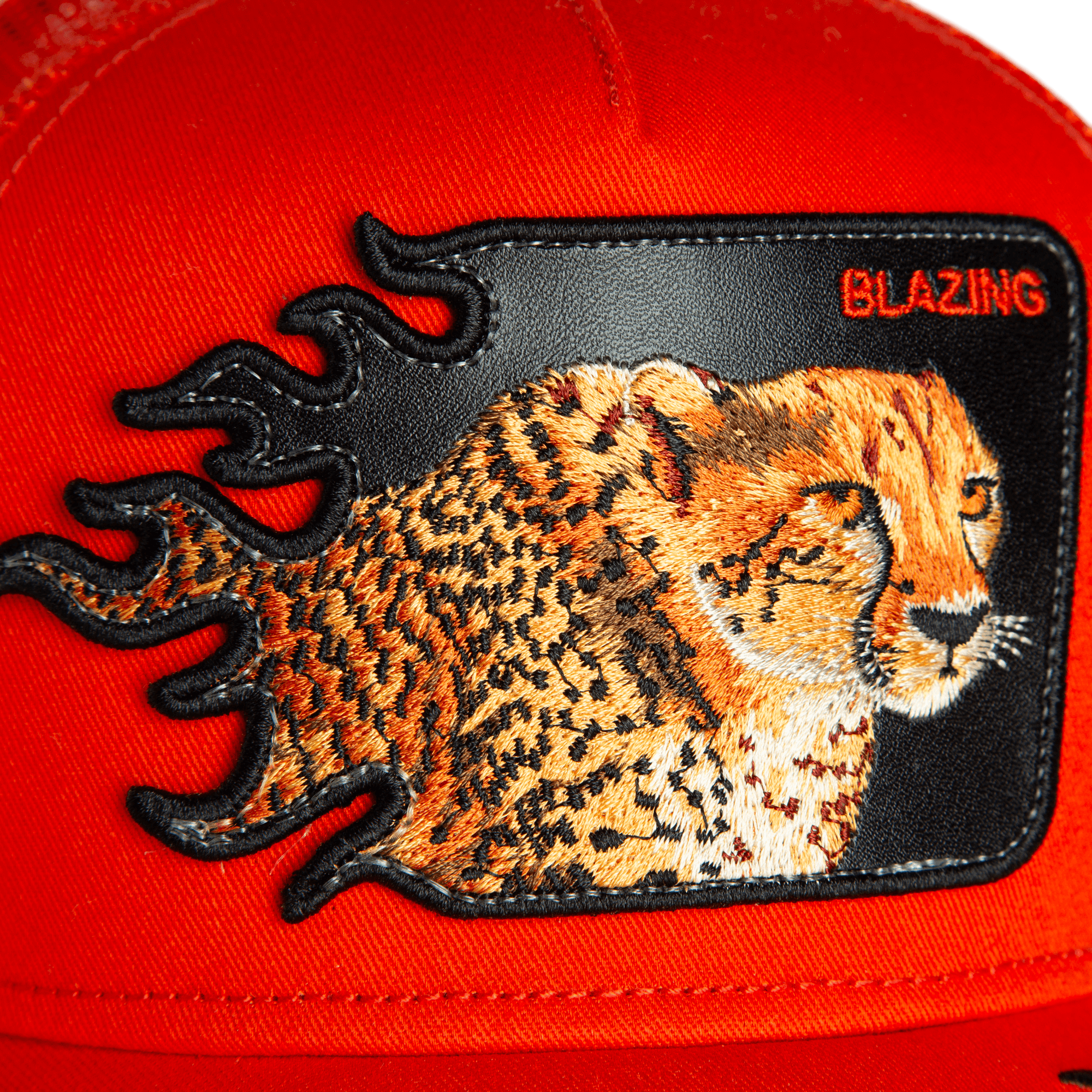 Close-up of the Goorin Bros. Blazing Flames cheetah hat with an embroidered patch featuring flame accents and "BLAZING" in the top right, perfect for trucker hat fans.