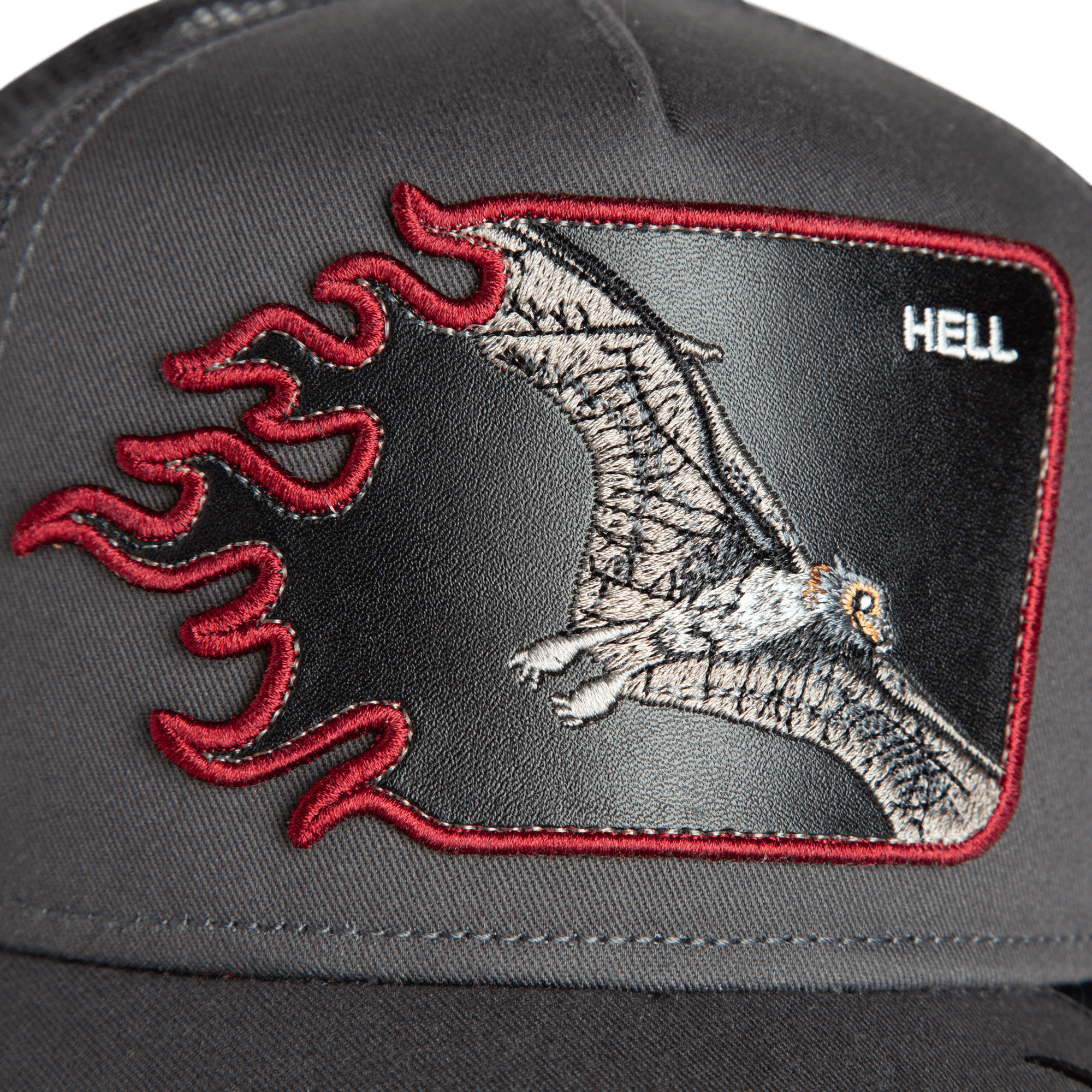 Close-up of the Goorin Bros. "Hell Flames" black trucker hat, featuring an embroidered bat patch, red flames, and the word HELL in the upper right corner.