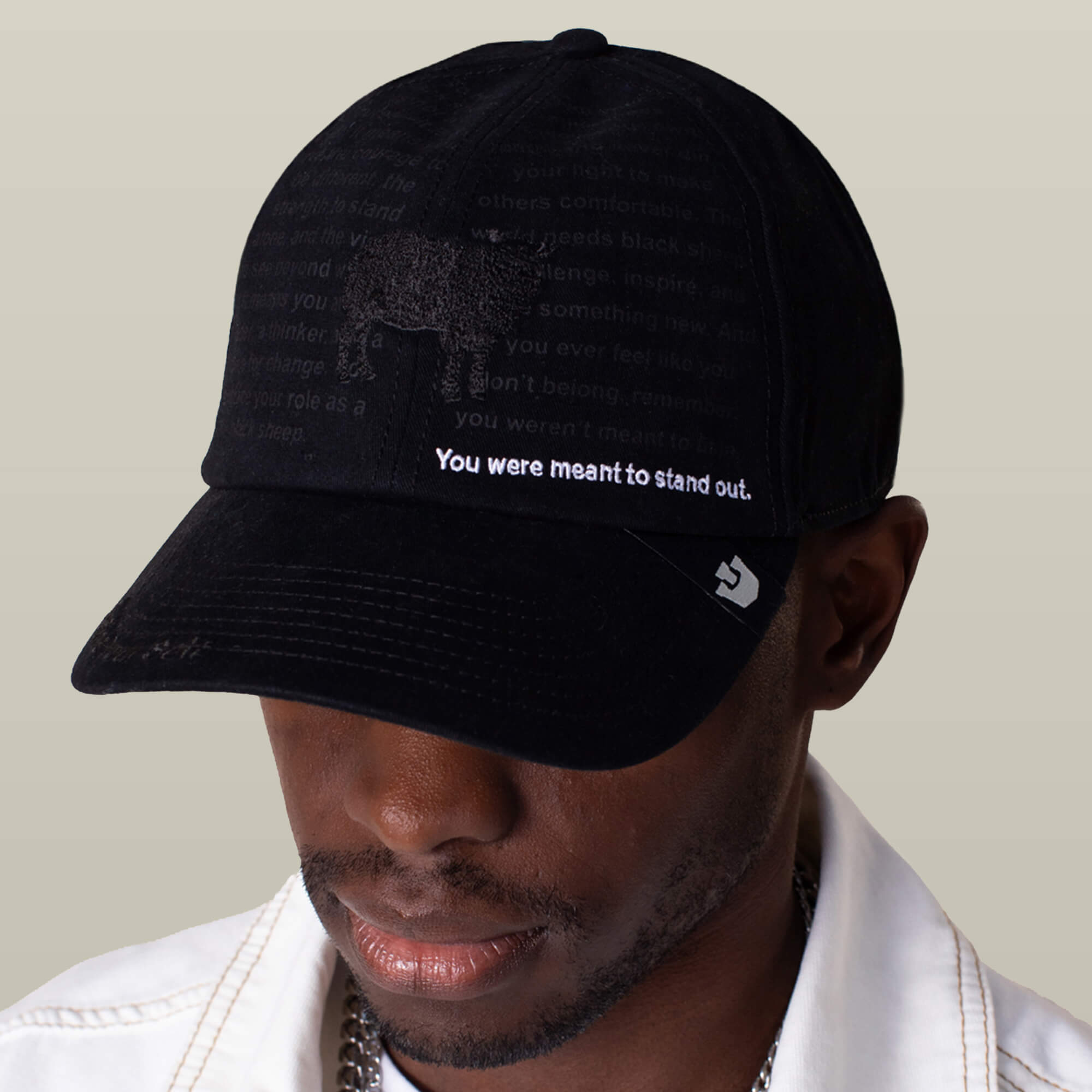 A person wears the Goorin Bros. Define Yourself - Black Sheep hat featuring "You were meant to stand out" text, a subtle animal graphic, and faded words.