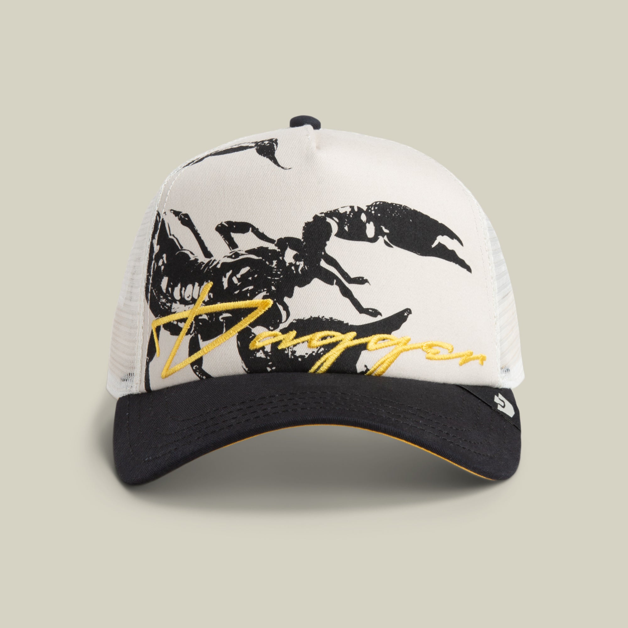 The Goorin Bros. Outside the Lines Scorpion cap in DUST / VOID features a mesh back, bold scorpion patch, and yellow "Duggan" script above the brim.
