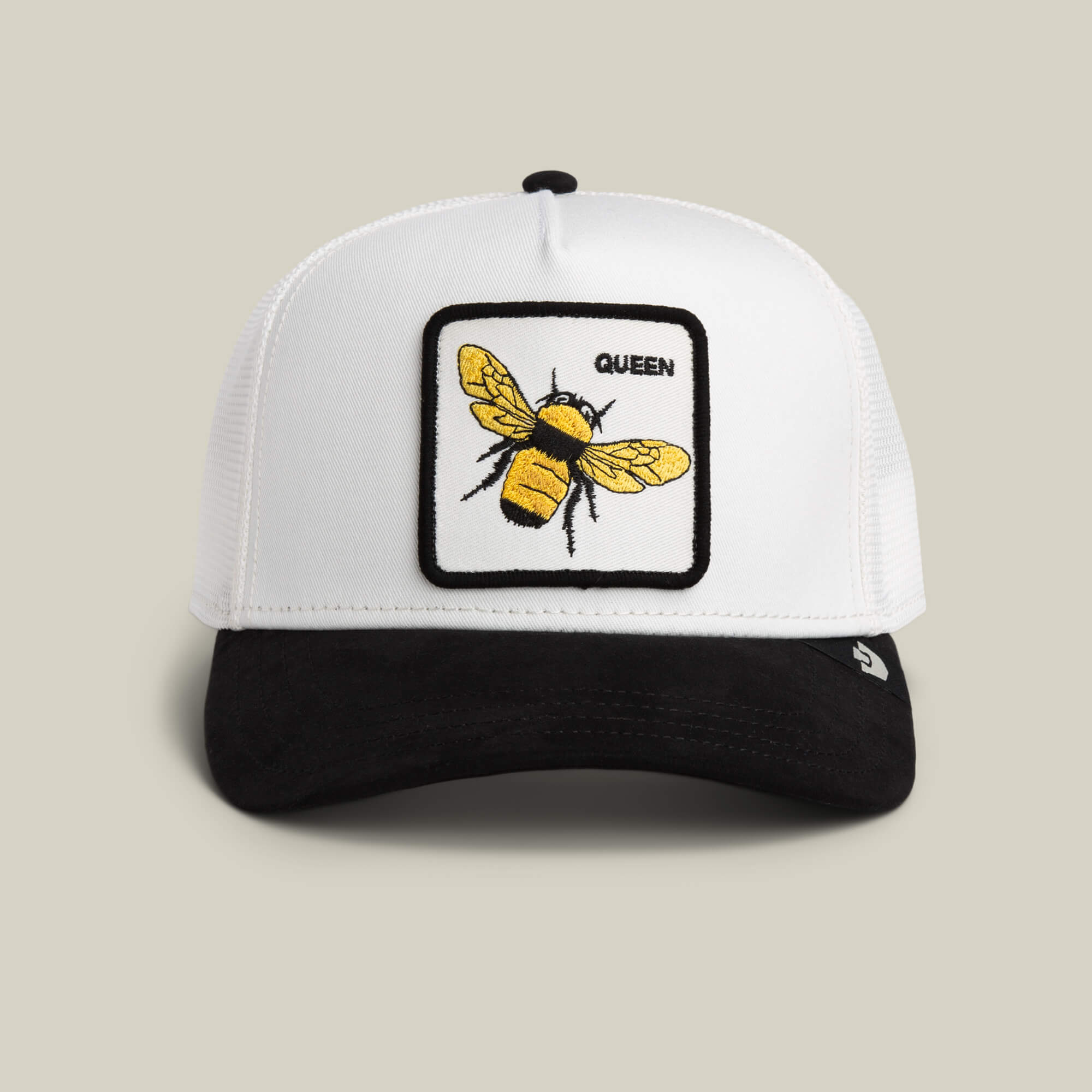 The Suede Bee by Goorin Bros. is a DUST/VOID trucker hat with a Queen patch, embroidered yellow bee, and sleek black microsuede brim for extra style.