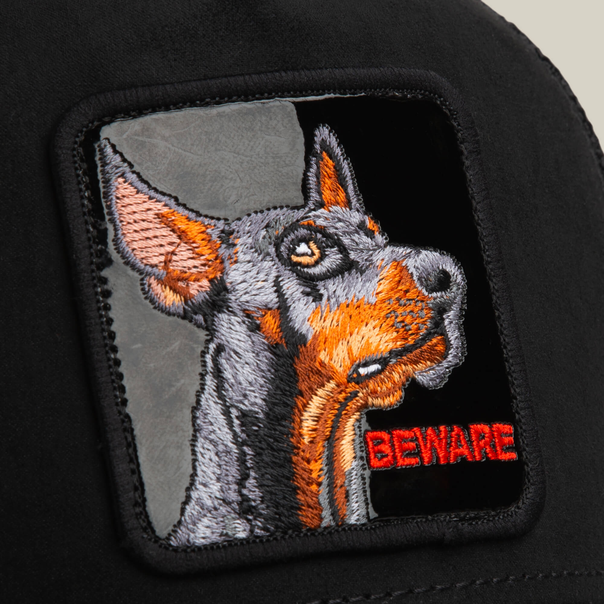 The Goorin Bros. Black Out Doberman patch features bold red "BEWARE" embroidery on sleek black suede—a standout animal patch perfect for customizing jackets or bags.