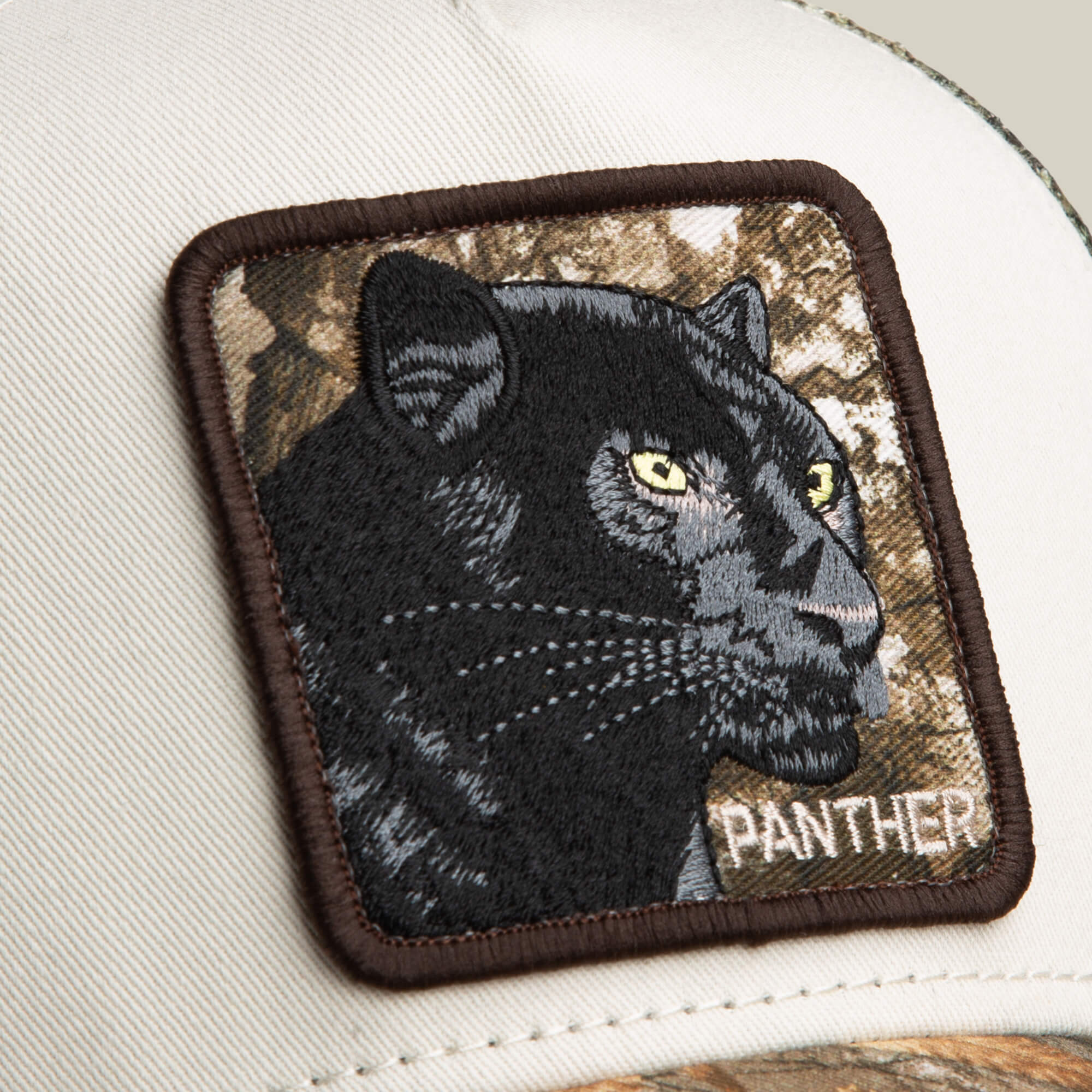 The Goorin Bros. Realtree Edge Black Panther cap features a bold embroidered panther patch labeled "PANTHER" on a white and camo colorway to elevate your style.