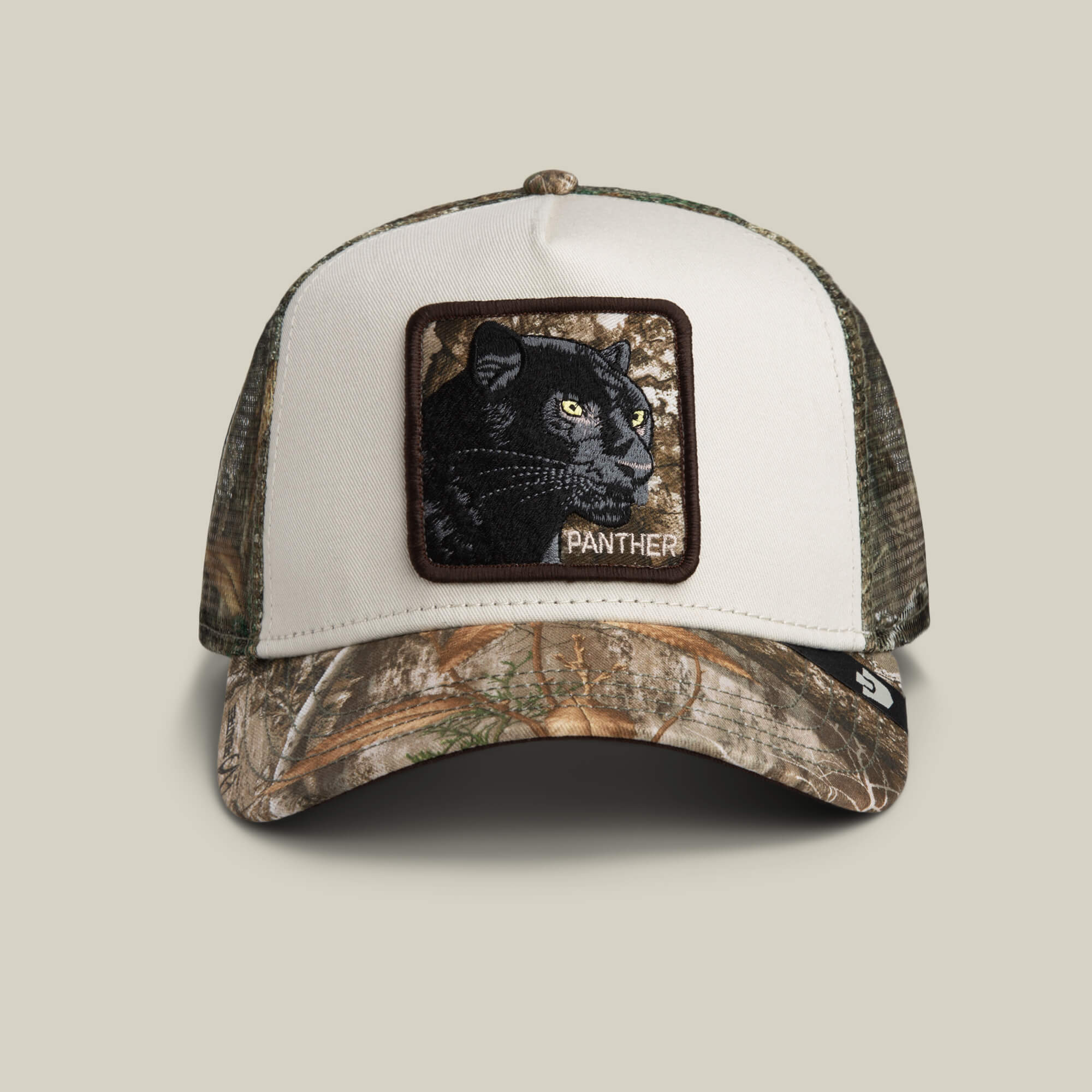 The Goorin Bros. Realtree Edge Black Panther trucker hat features a camouflage bill and mesh, with a front panel patch displaying a panther and the word “PANTHER” embroidered below.
