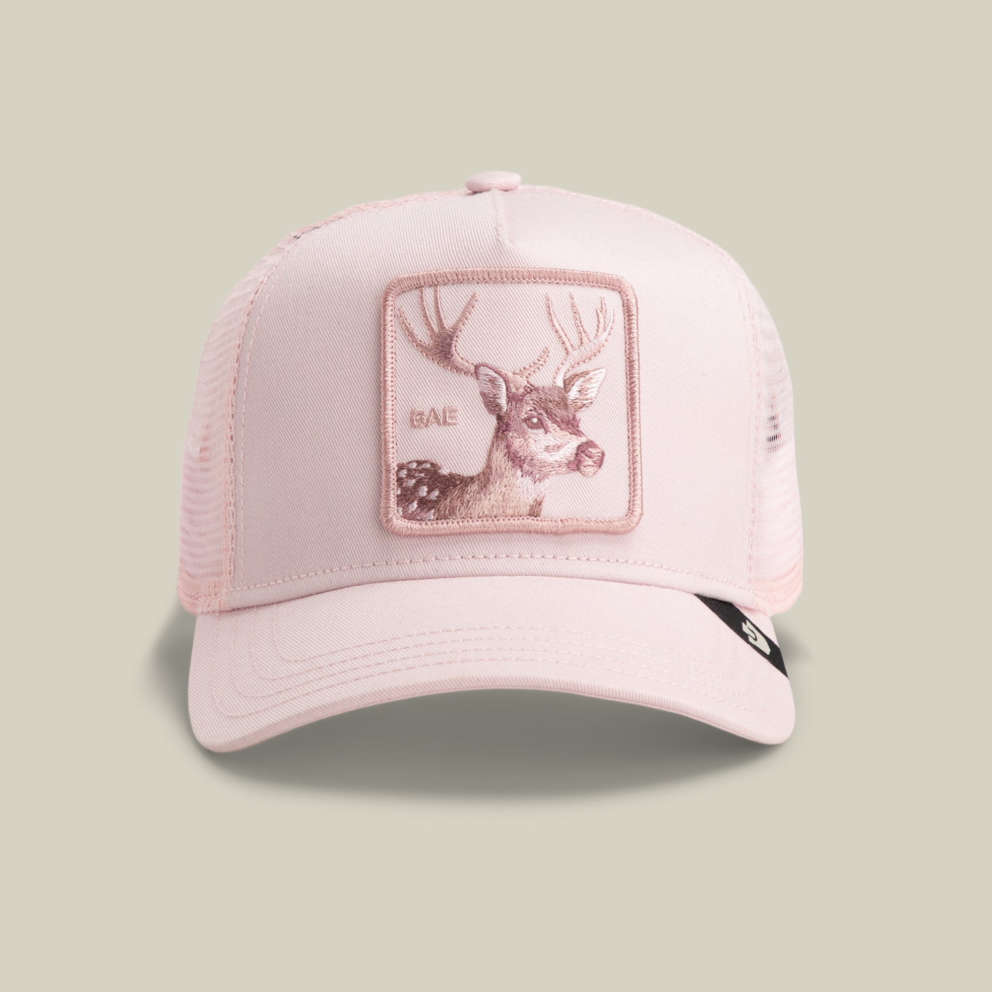 The Goorin Bros. Mirage Bae trucker hat in WHISPER features a light pink design with a mesh back and a front deer patch embroidered with "BAE.