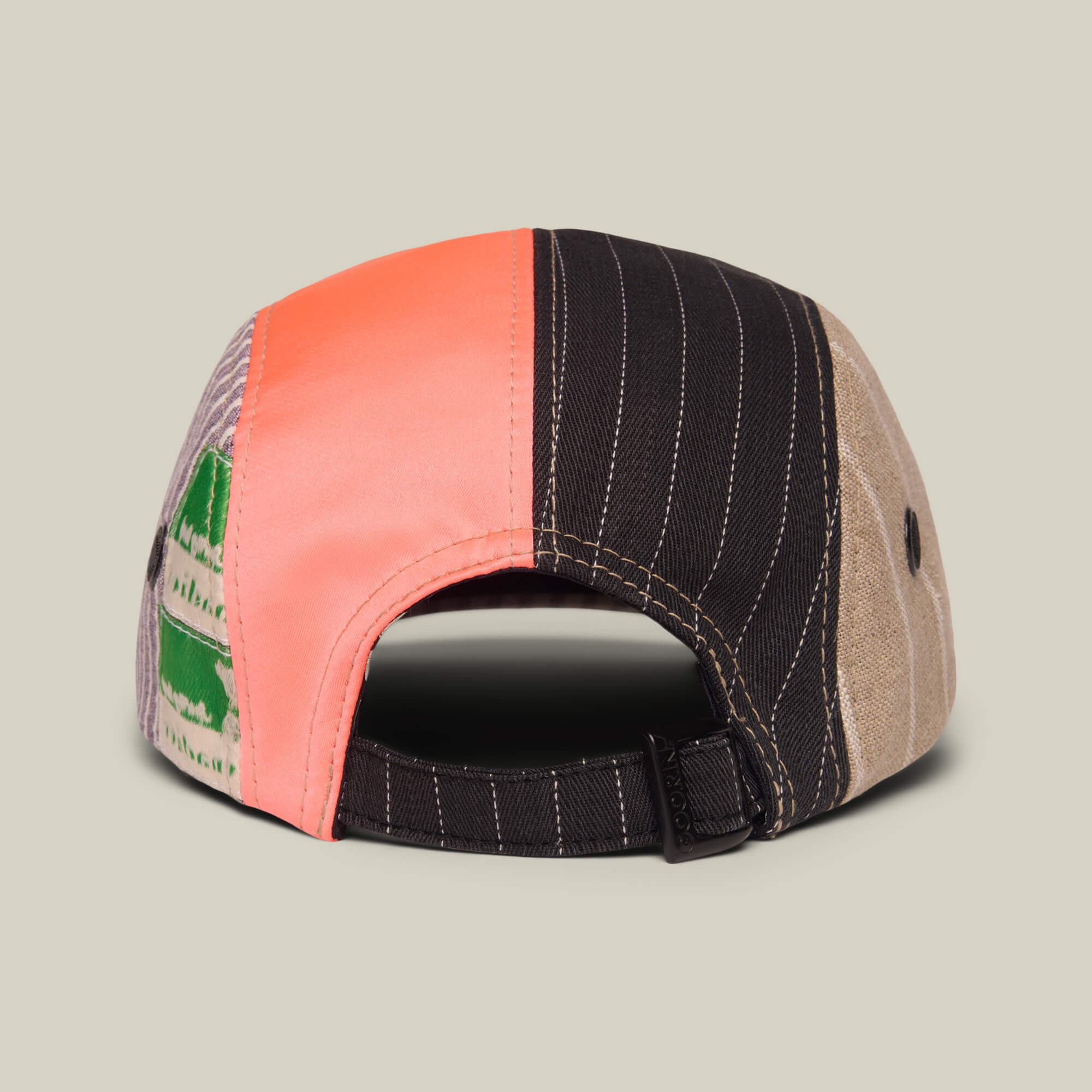 The Goorin Rework Camper by Goorin Bros. is a limited edition recycled camp cap, shown from the back, with pink, black pinstripe, tan, and green patterned panels and an adjustable strap. Made in the USA.