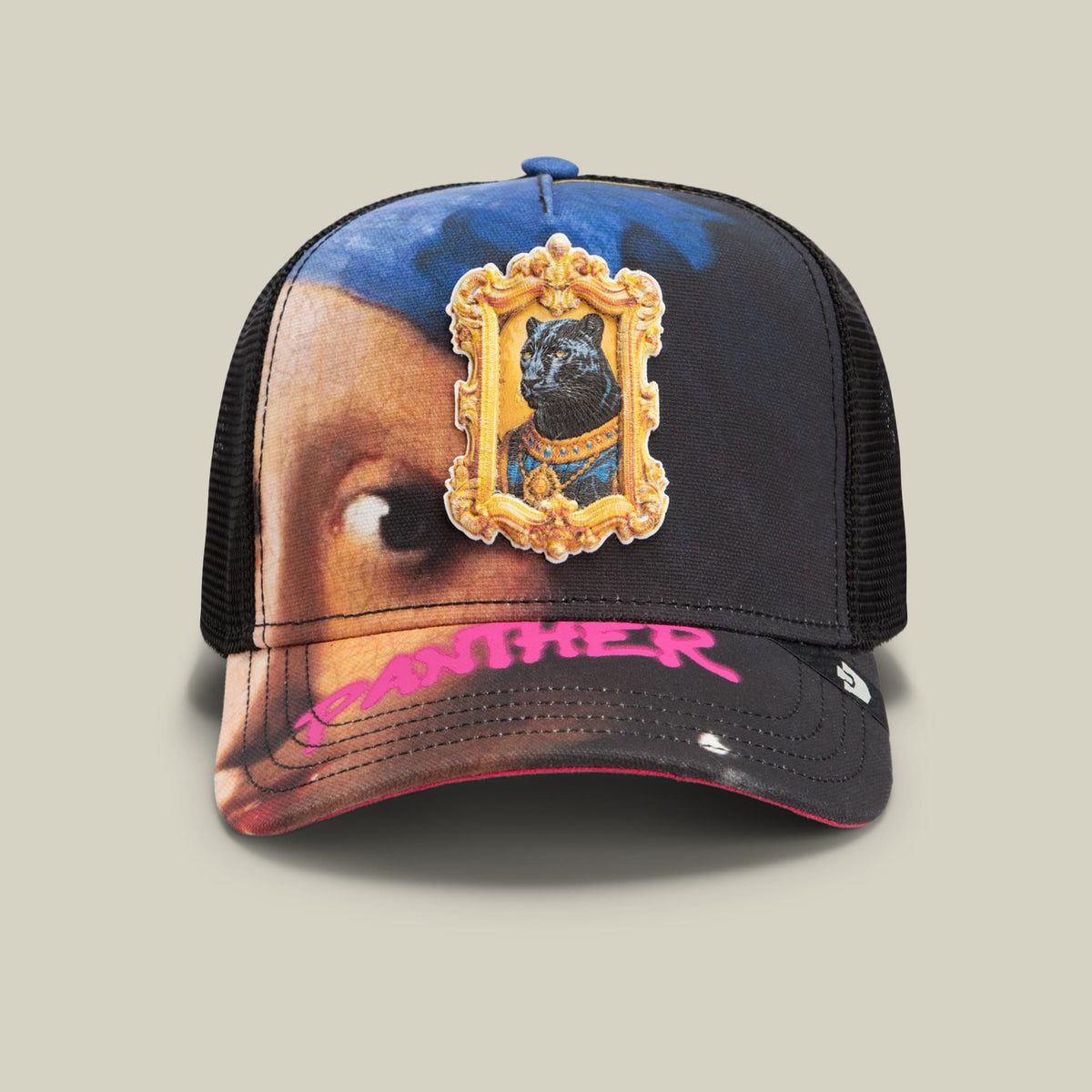 The Girl with the Pearl Necklace trucker hat by Goorin Bros features a mesh back with an ornate gold-framed cat portrait patch on the front, set against a surreal portrait background with pink and black accents on the bill.