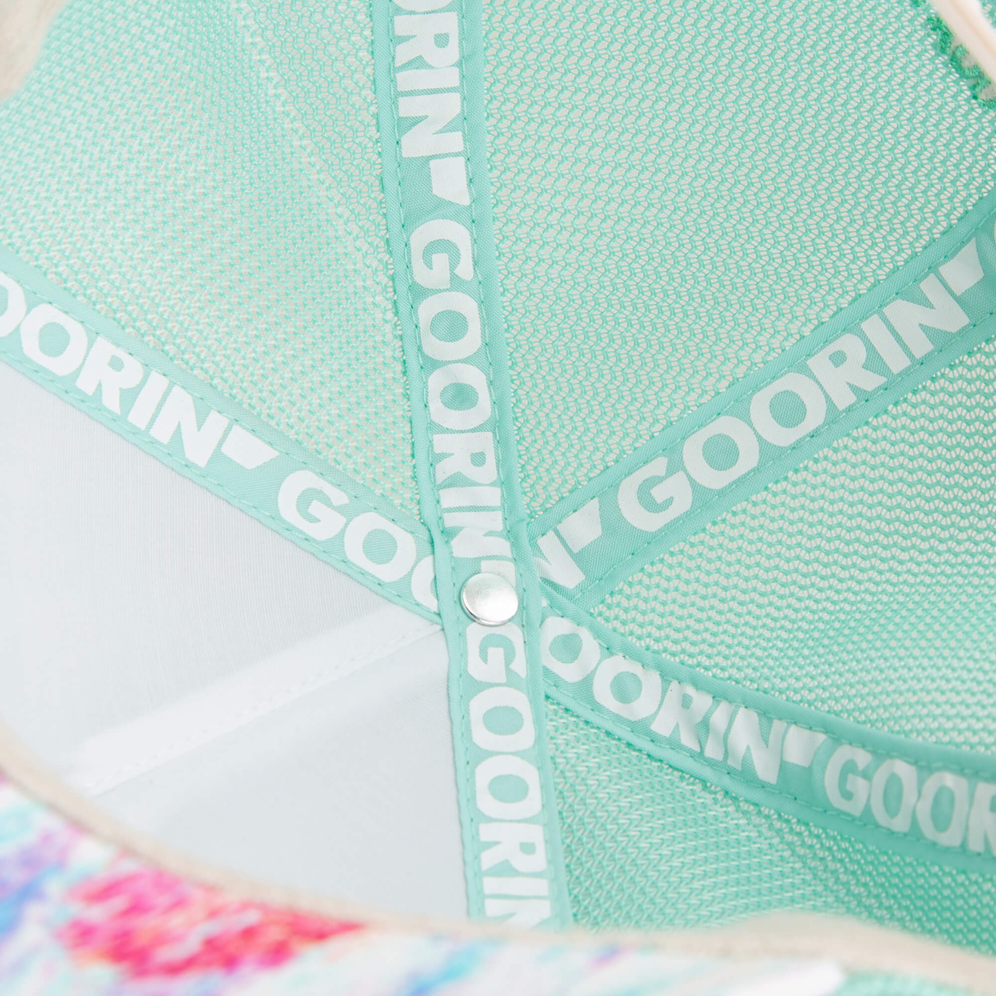 Close-up of the inside of the Magic Eye hat by Goorin Bros., featuring mint green mesh lining and white Goorin branding on the inner seams for a mirage-like optical illusion effect.