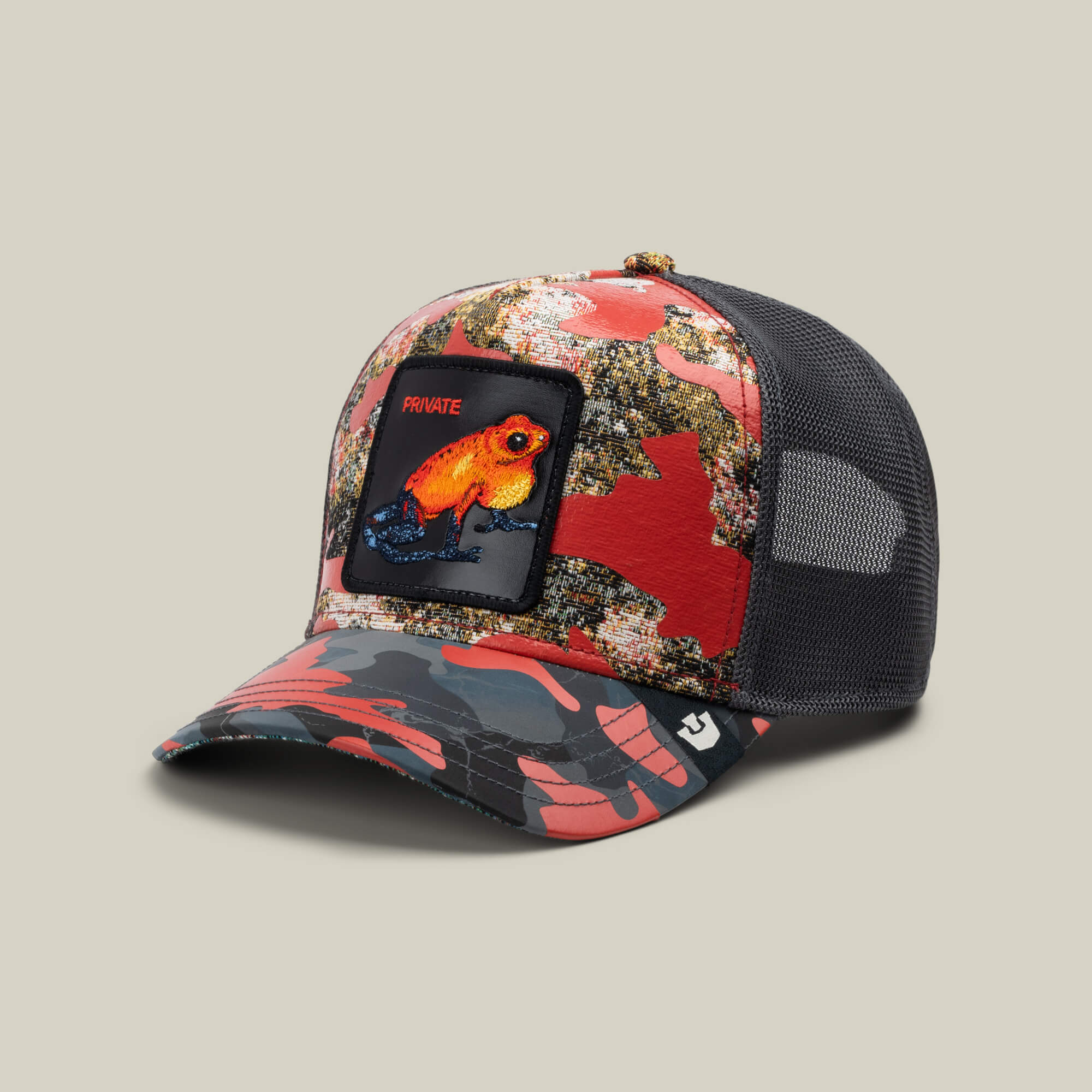 The Secret Service by Goorin Bros. is a red camo trucker hat with a black mesh back and a front patch featuring an orange and blue frog labeled PRIVATE—ideal for standout Private Red Rank style.