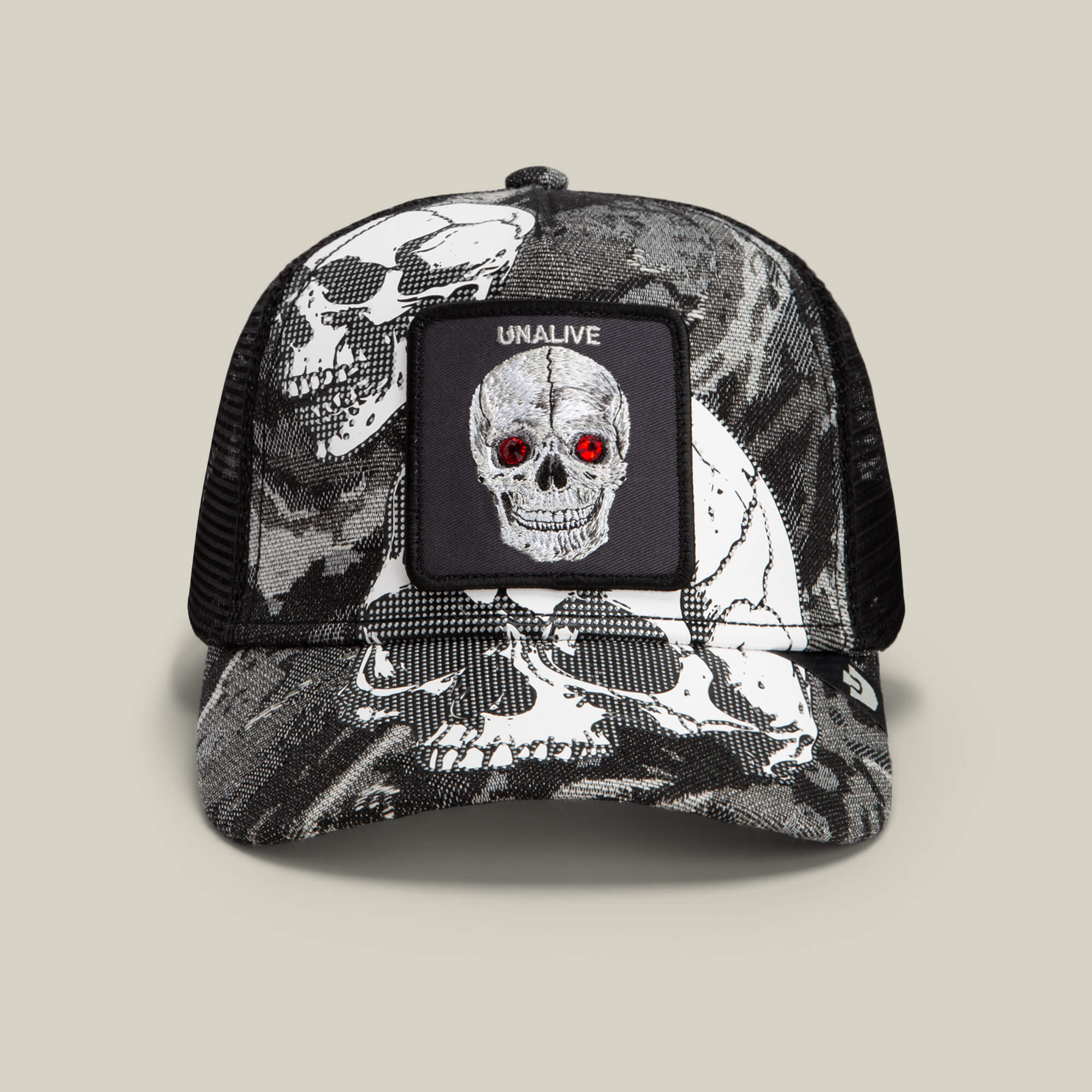 The Goorin Bros. Bone Head Unalive trucker hat in Void features a striking black and white skull print with vivid red eyes, a bold “UNALIVE” patch above the graphic, and a skull pattern across the front and brim. Finished with a breathable mesh back for all-day comfort, this classic design expertly combines edgy style with signature Goorin Bros. craftsmanship.