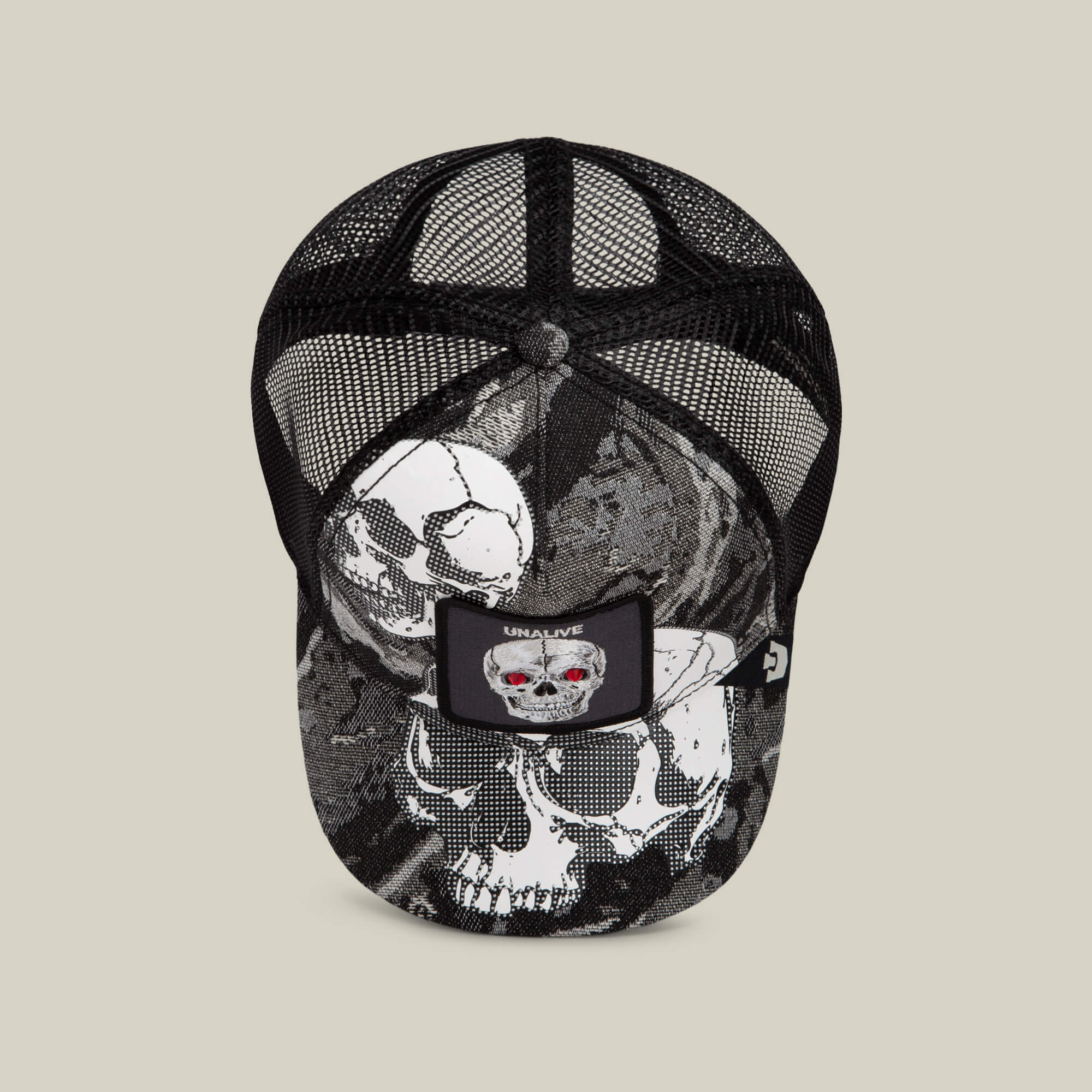Introducing the Goorin Bros. Bone Head Unalive trucker hat: a black mesh baseball cap with striking white and gray skull graphics, accented by a front patch featuring a skull with red eyes and “UNALIVE” text. Designed for comfort, this Goorin Bros. hat offers a breathable mesh back ideal for all-day wear.