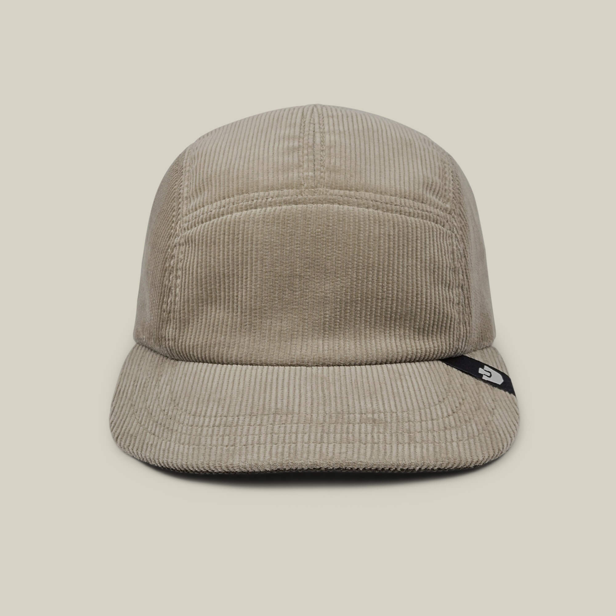The Goorin Bros. Meadow Creek is a Toast Tan cotton corduroy 5-panel camp cap with a short brim, front view, and a small black tag with white logo on the brim's side. Made in USA.