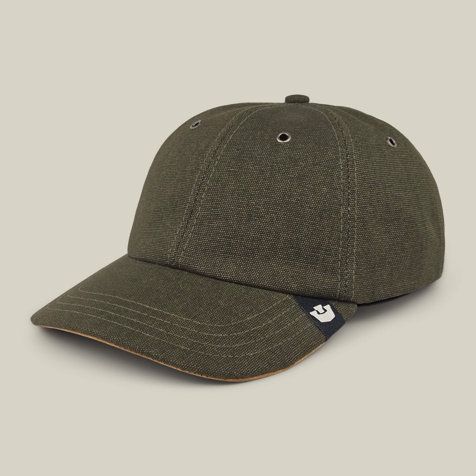 The Goorin Bros. Mineral Road is a dark green mixed-material baseball cap with a curved brim, visible stitching, metal eyelets, and a small logo tag on the side. Made in the USA.