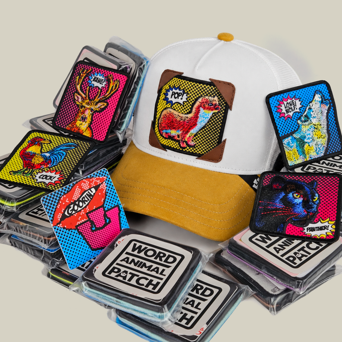 A white and tan Popart Patch Pack with GB Patch Corner Trucker - Tan featuring a ferret design, surrounded by a collection of colorful POPArt animal patches in protective plastic packaging.