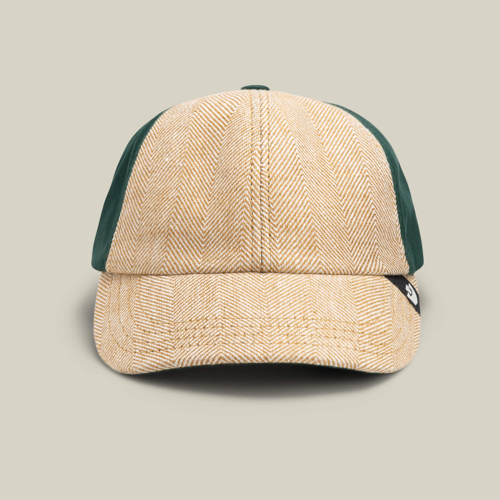 The Goorin Bros. Zig Zag Tailored Baseball cap in BEAM features a beige herringbone front and solid dark green textured side panels, shown from the front against a plain background.